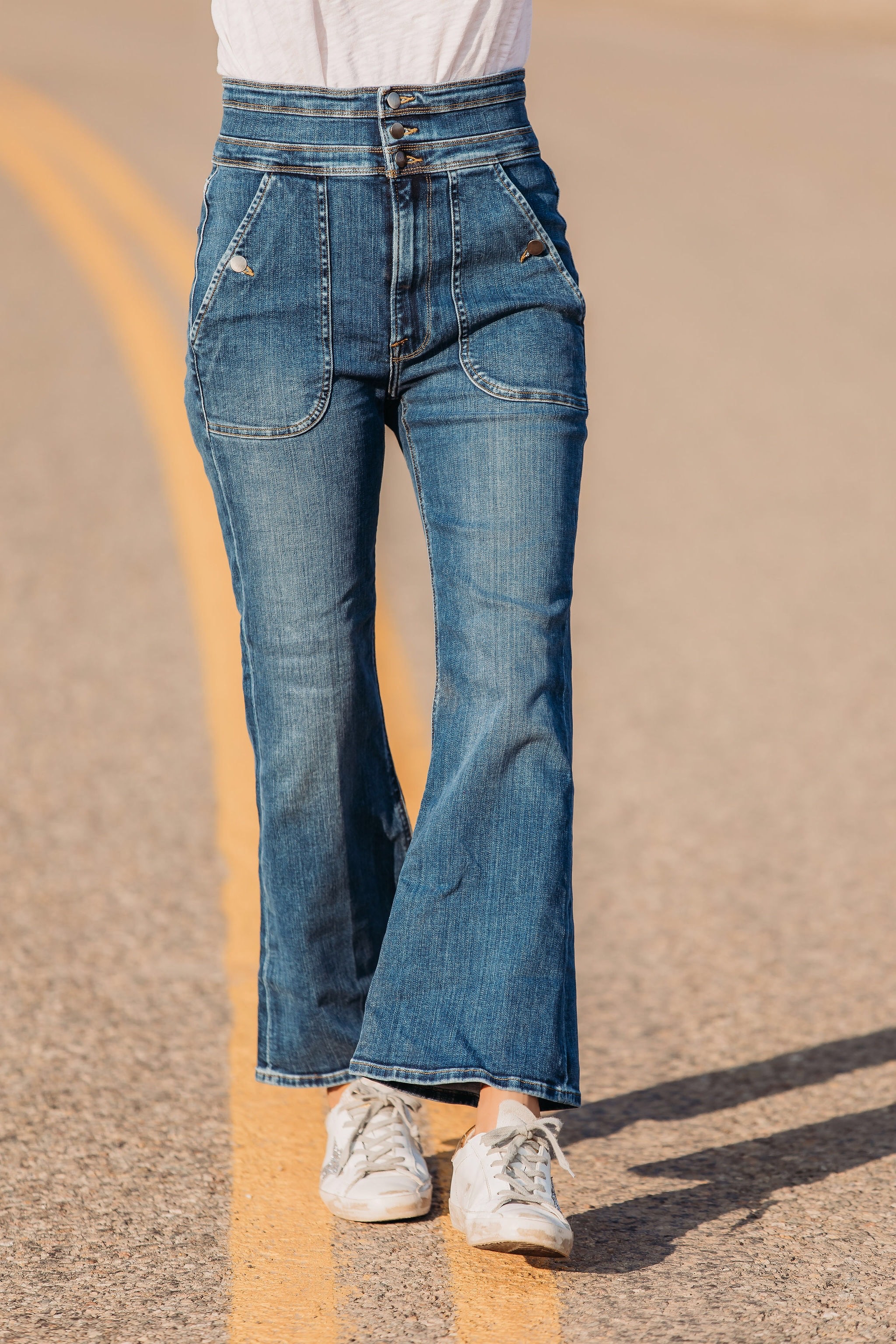 Summer Mom Style, Fashion blogger Erin Busbee of Busbee Style wearing a white v-neck tee with wide leg flare jeans by Frame, Golden Goose sneakers, Julie Vos bracelets, Aligheri necklaces, and Saint Laurent sunglasses in Telluride, Colorado