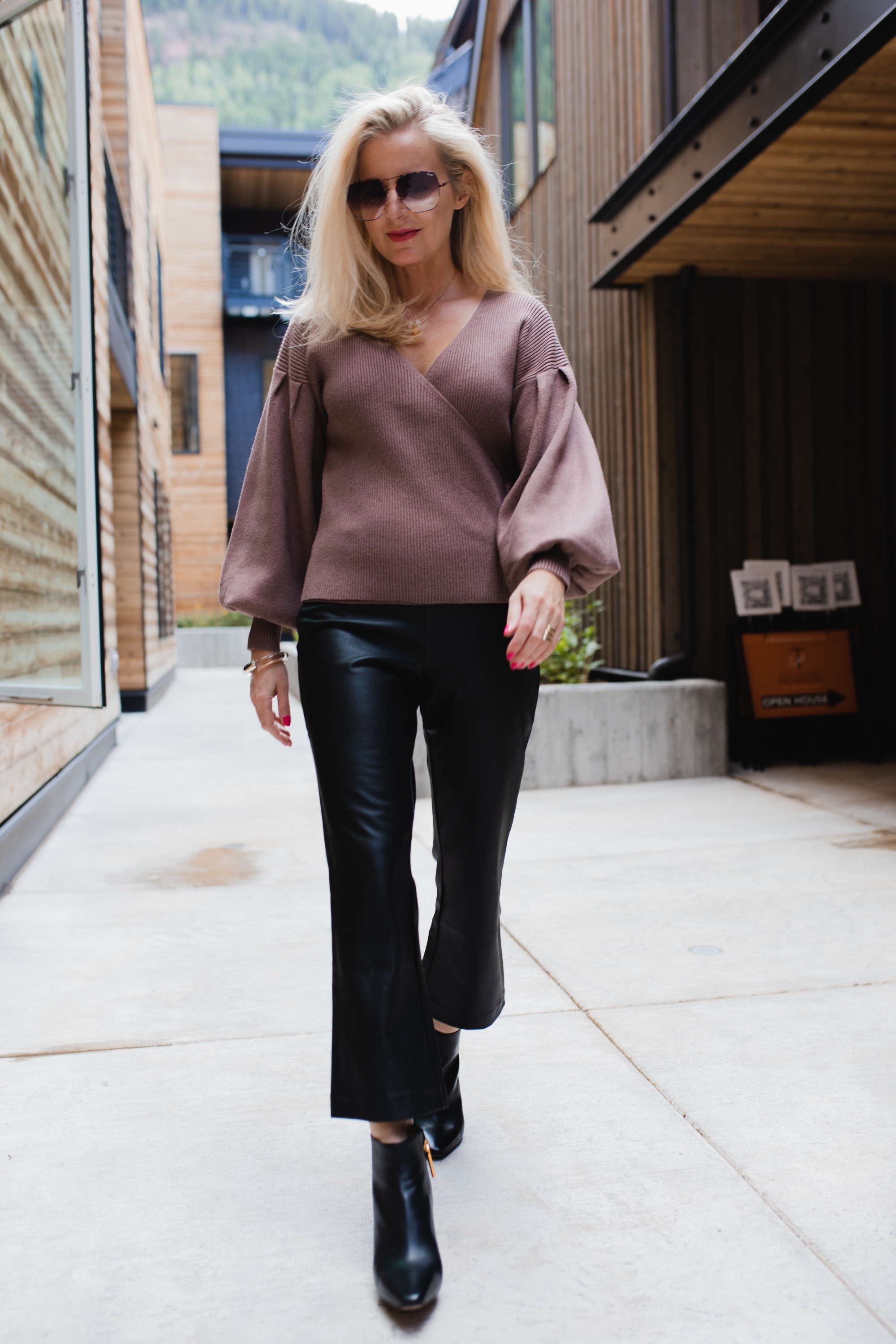 How To Wear Leather Pants, Fashion Blogger Erin Busbee Of Busbee Style Wearing Black Faux Leather Pants By Halogen With A Brown All In Favor Bishop Sleeve Sweater, Black Louise Et Cie Booties, And Brown Quay Sunglasses In Telluride, Colorado