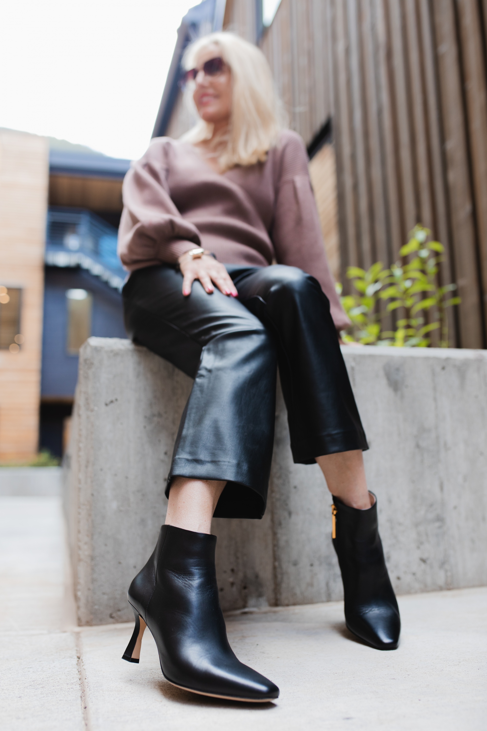 How To Wear Leather Pants, Fashion Blogger Erin Busbee Of Busbee Style Wearing Black Faux Leather Pants By Halogen With A Brown All In Favor Bishop Sleeve Sweater, Black Louise Et Cie Booties, And Brown Quay Sunglasses In Telluride, Colorado