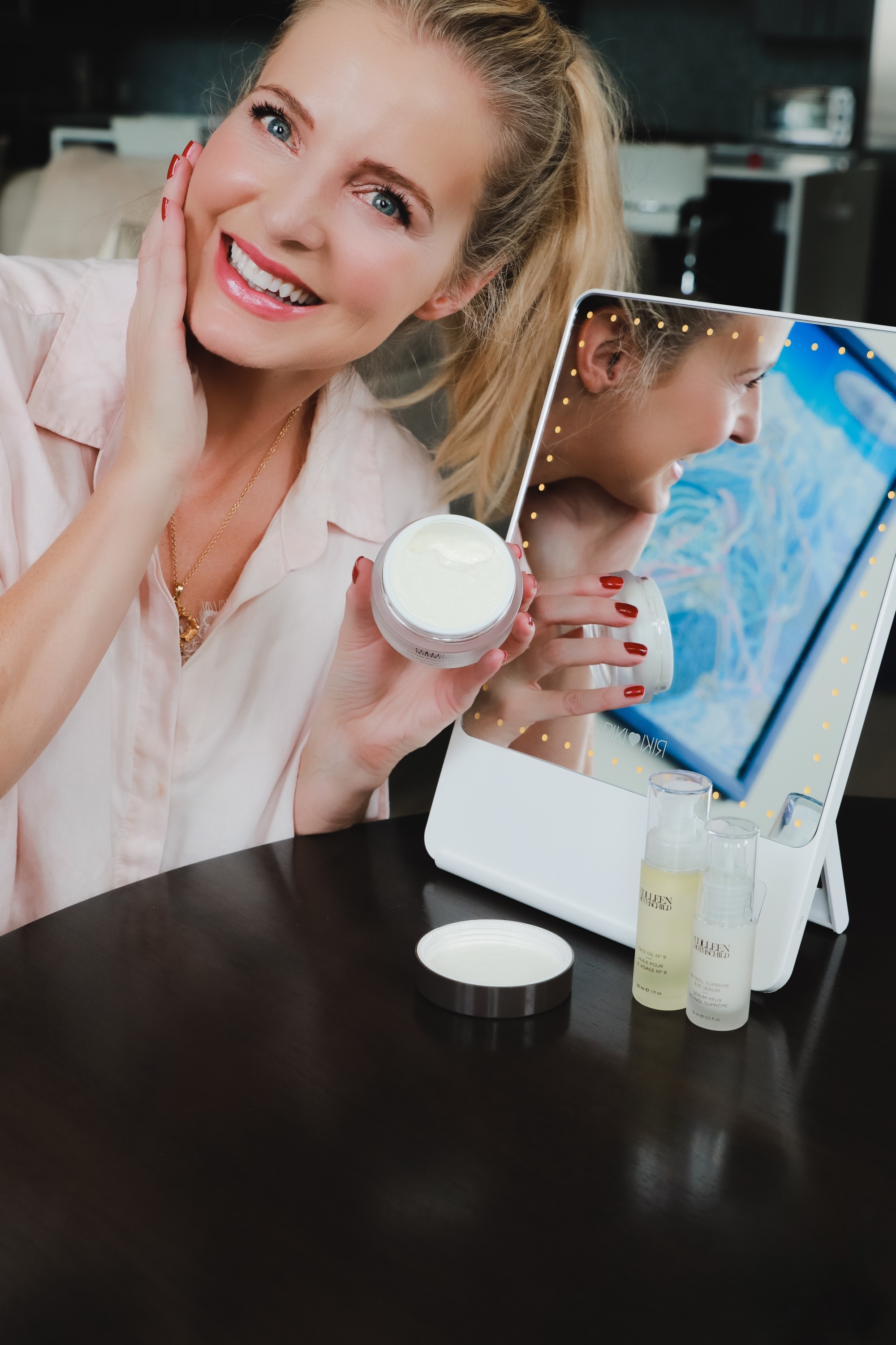 Favorite Skincare Brand, Erin Busbee of Busbee Style using the Colleen Rothschild Extreme Recovery Cream moisturizer in front of her portable mirror in her home in Telluride, Colorado