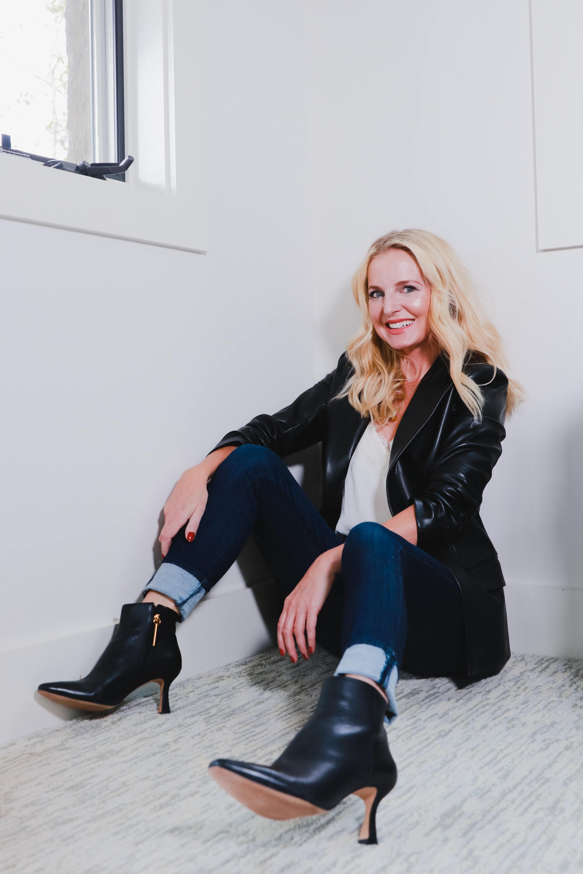 Boots With Jeans, Erin Busbee of Busbee Style sharing the complete guide to wearing jeans and booties wearing Frame skinny jeans, Louise et Cie black booties, a black Theory faux leather blazer, and white BP lace cami in her home in Telluride, Colorado