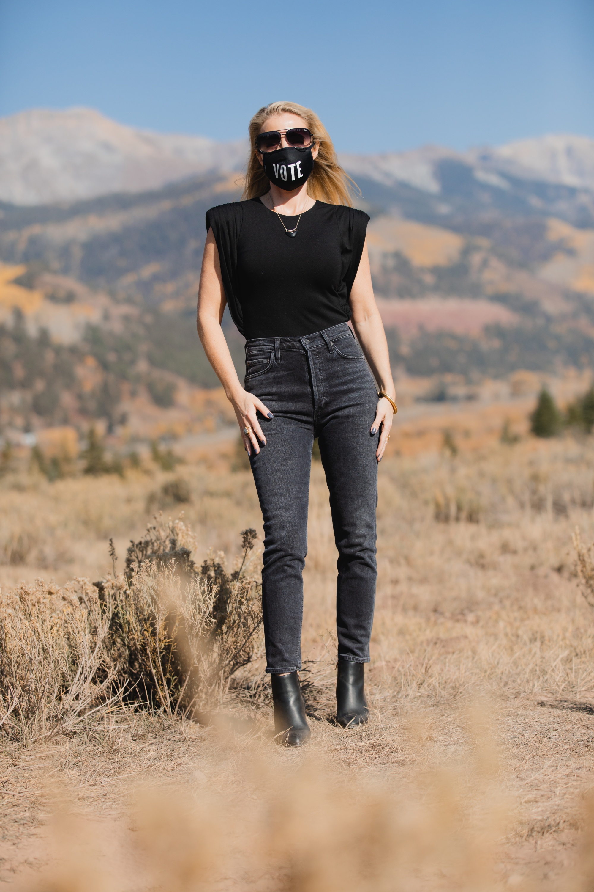 How To Wear A Cargo Jacket, Erin Busbee of Busbee Style wearing a black muscle tee tank by Aqua, gray wash Nico slim fit jeans by Agolde, QUAY sunglasses, Vote mask, and Alexander Wang cutout booties from Bloomingdale's in Telluride, Colorado