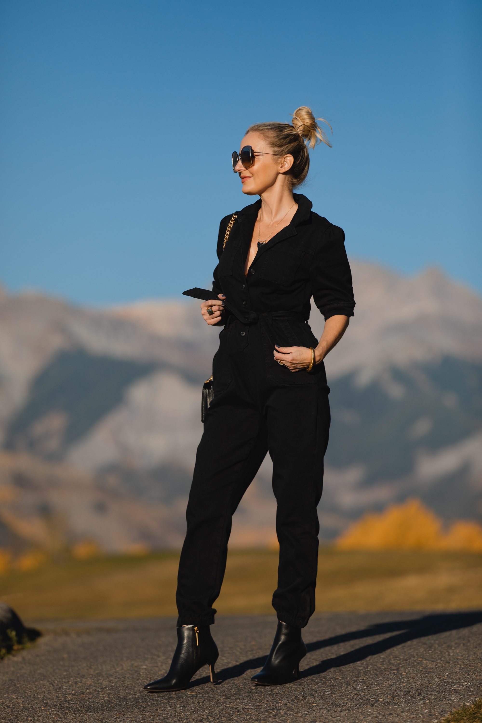 Edgy Black Jumpsuit, Erin Busbee of Busbee Style wearing a black Paige jumpsuit with black Louise et Cie booties, black Chanel boy bag, and Salvatore Ferragamo sunglasses in Telluride, Colorado