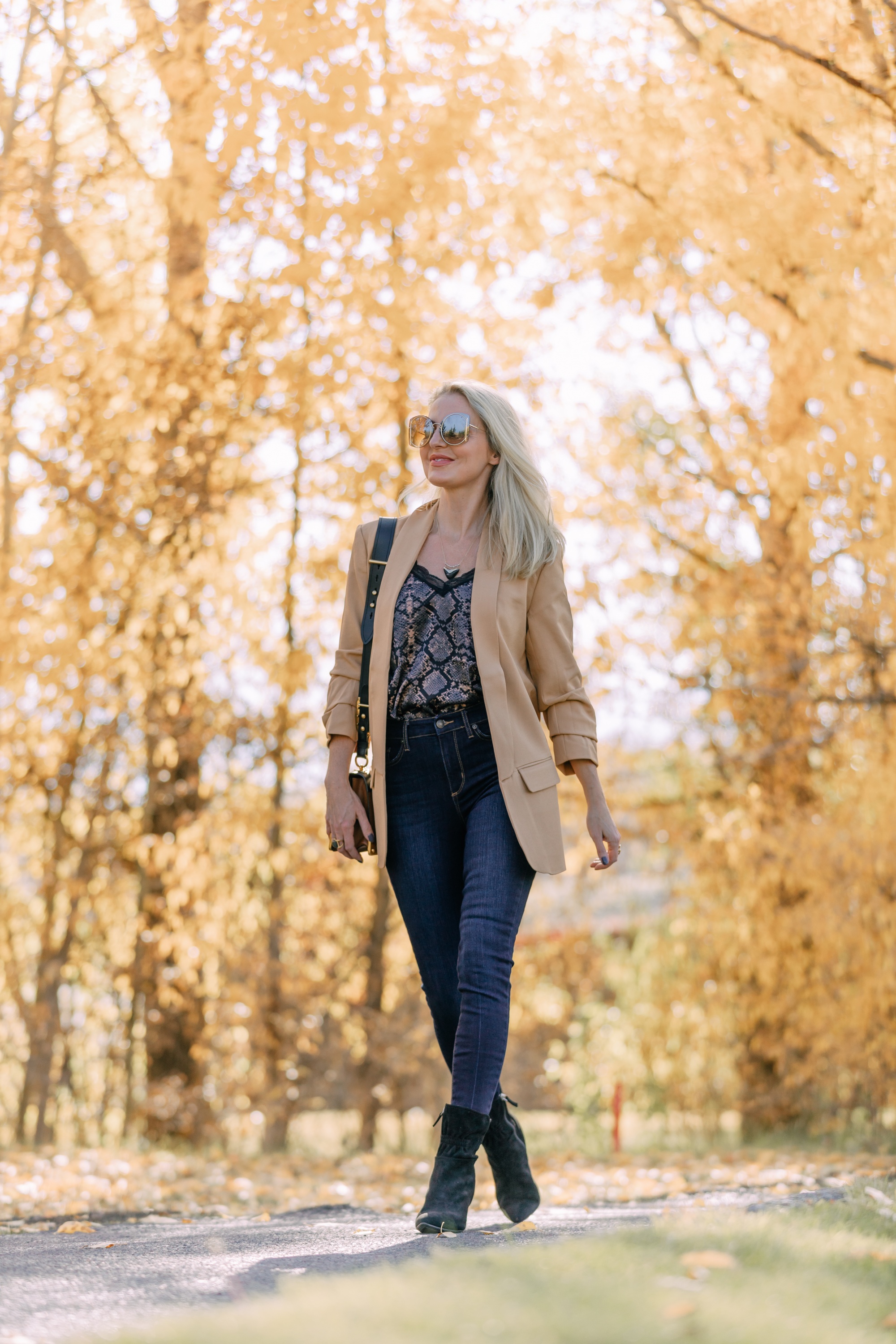 Affordable Fall Fashion, Erin Busbee of Busbee Style wearing dark wash skinny jeans by Scoop, a camel boyfriend blazer by Scoop, a black lacy python print camisole by Scoop, black scrunch stiletto booties by Scoop, Prada Cahier black and brown bag, and Salvatore Ferragamo sunglasses in Telluride, Colorado