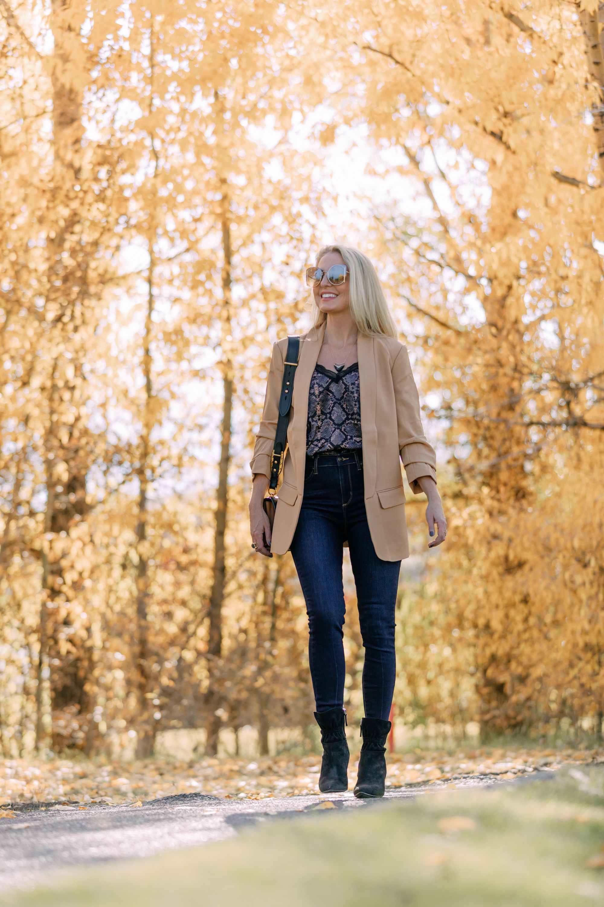 Affordable Fall Fashion, Erin Busbee of Busbee Style wearing dark wash skinny jeans by Scoop, a camel boyfriend blazer by Scoop, a black lacy python print camisole by Scoop, black scrunch stiletto booties by Scoop, Prada Cahier black and brown bag, and Salvatore Ferragamo sunglasses in Telluride, Colorado