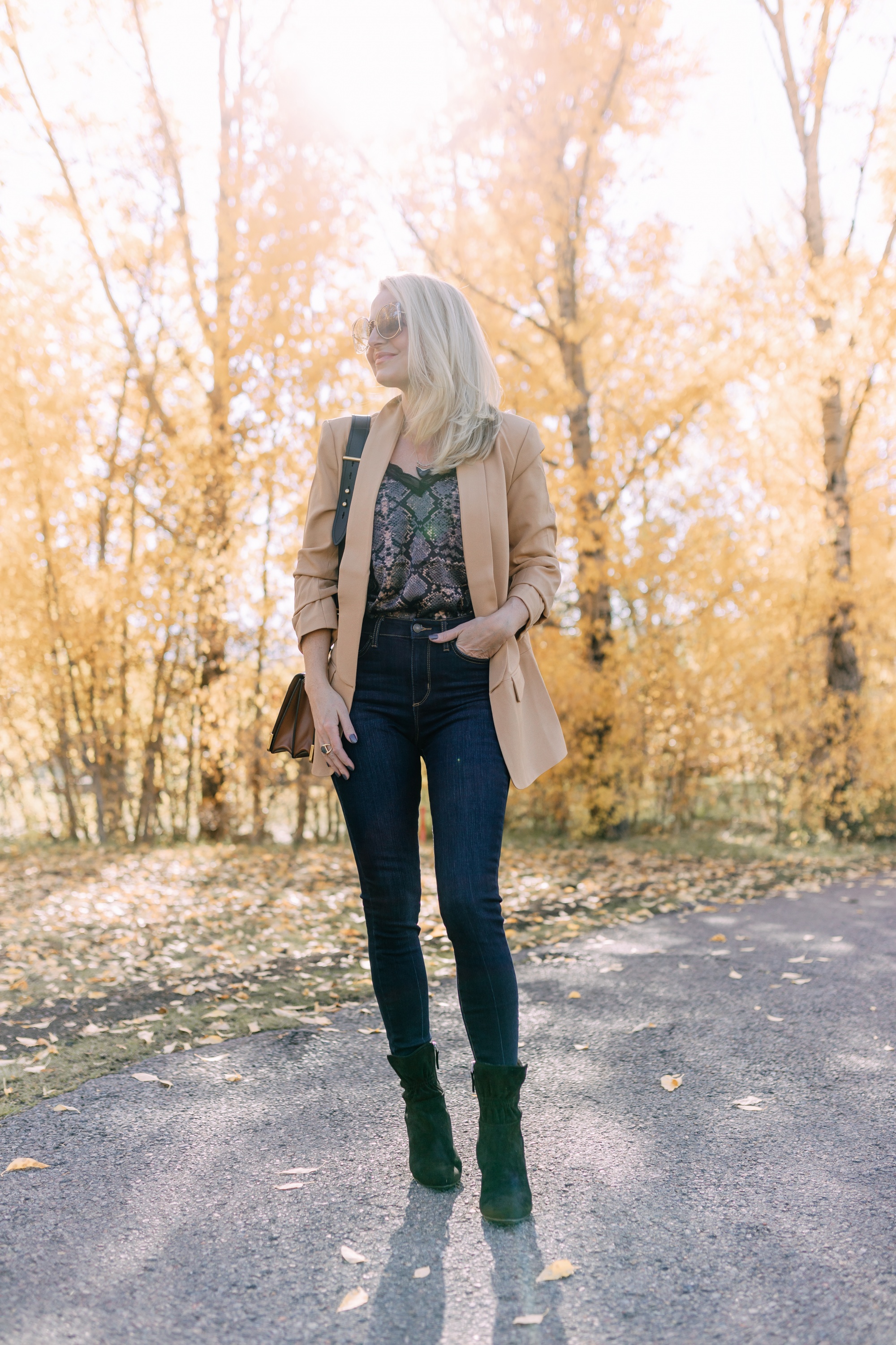 Affordable Fall Fashion, Erin Busbee of Busbee Style wearing dark wash skinny jeans by Scoop, a camel boyfriend blazer by Scoop, a black lacy python print camisole by Scoop, black scrunch stiletto booties by Scoop, Prada Cahier black and brown bag, and Salvatore Ferragamo sunglasses in Telluride, Colorado