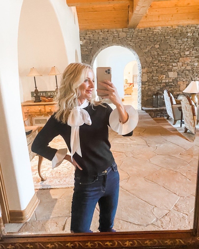 Layered Sweater, Erin Busbee of Busbee Style wearing a black and white tie neck sweater by Alice + Olivia with dark wash skinny jeans in Telluride, Colorado