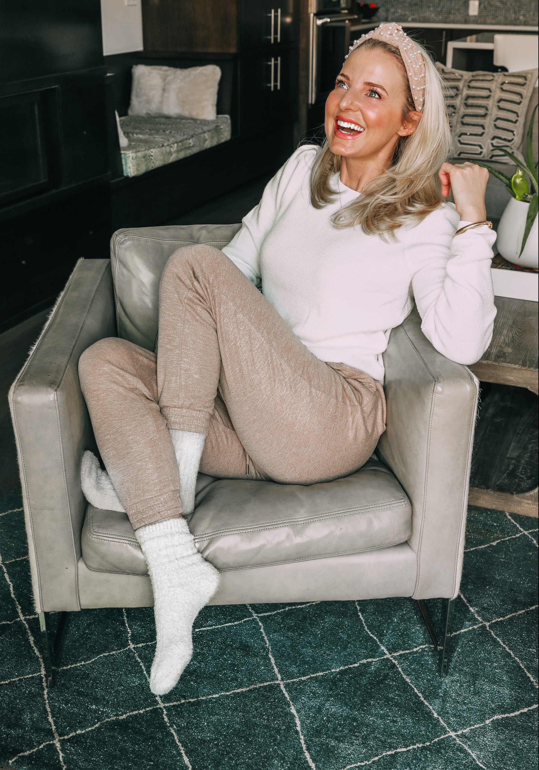 Loungewear over 40, how to look chic and polished fashion over 40 blogger Erin Busbee wearing Express metallic joggers and white ribbed puff shoulder sweater with pearl headband and fuzzy socks
