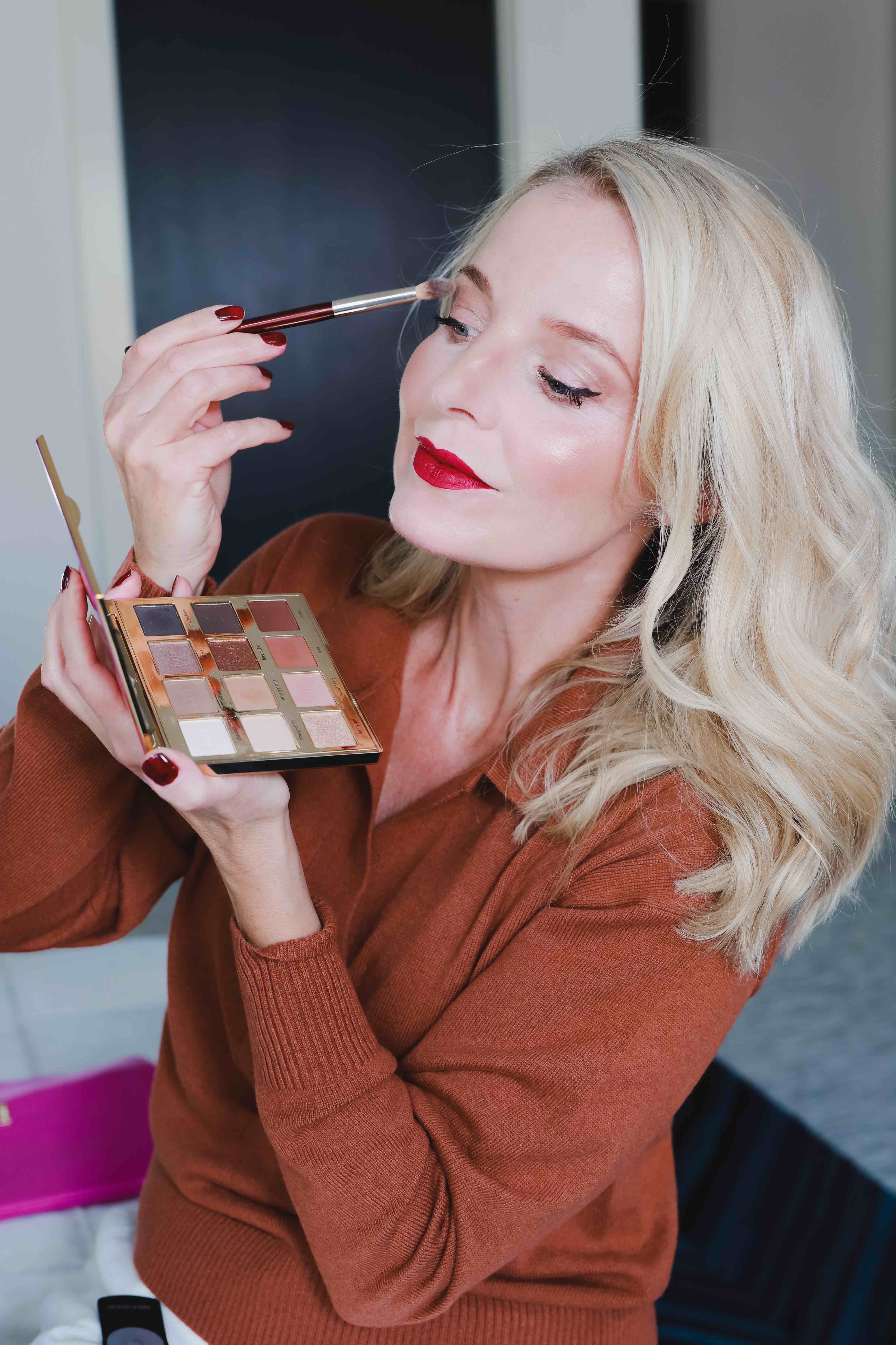 Best Vegan Makeup Brands, Erin Busbee of Busbee Style putting on vegan makeup eyeshadow by Tarte Cosmetics in her room in Telluride, Colorado