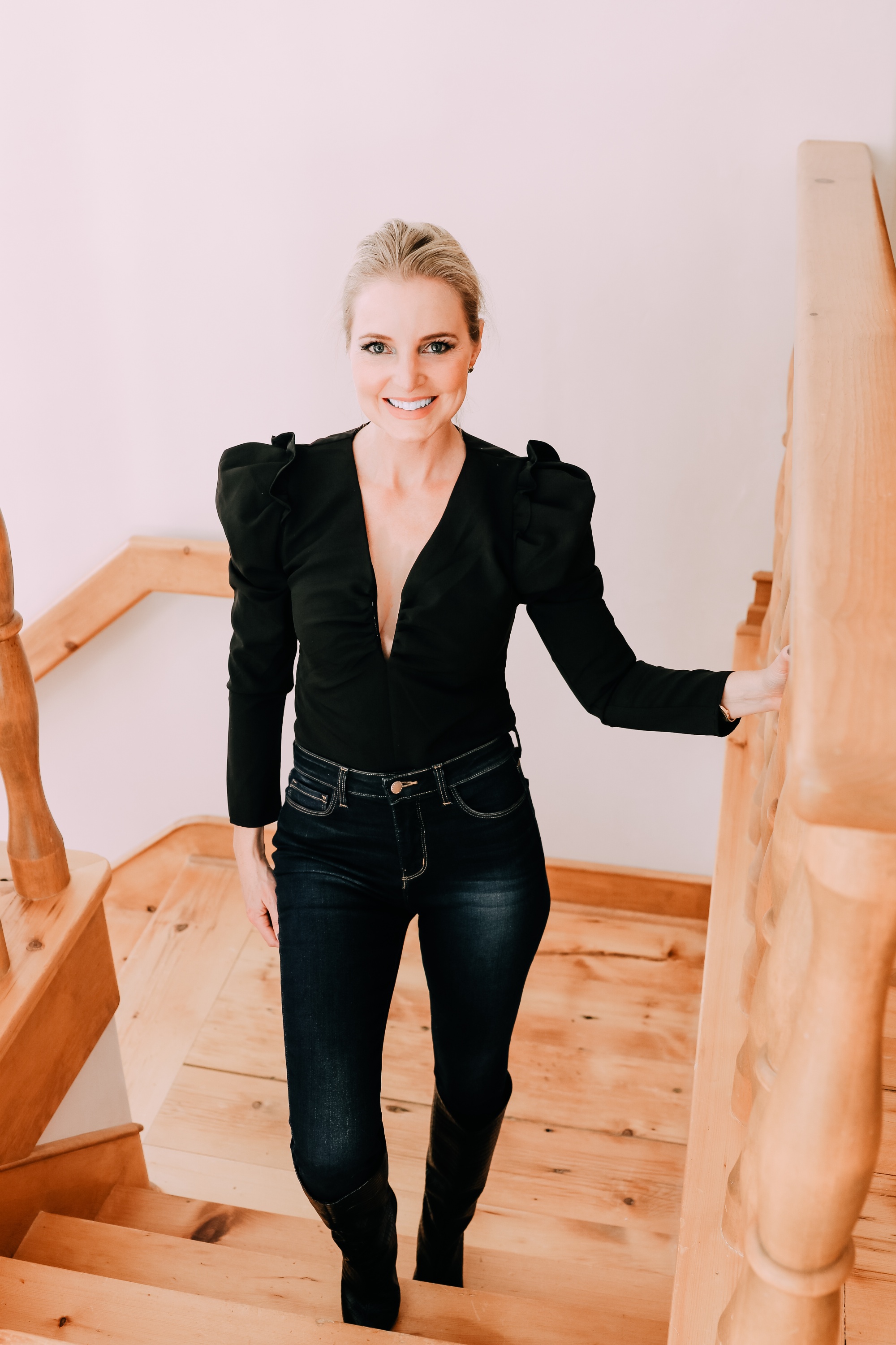 Holiday Outfits With Jeans, Erin Busbee of Busbee Style wearing a black ASTR the Label puff sleeve bodysuit, L'Agence dark wash skinny jeans, and black snake embossed boots by Schutz from Nordstrom in Telluride, Colorado