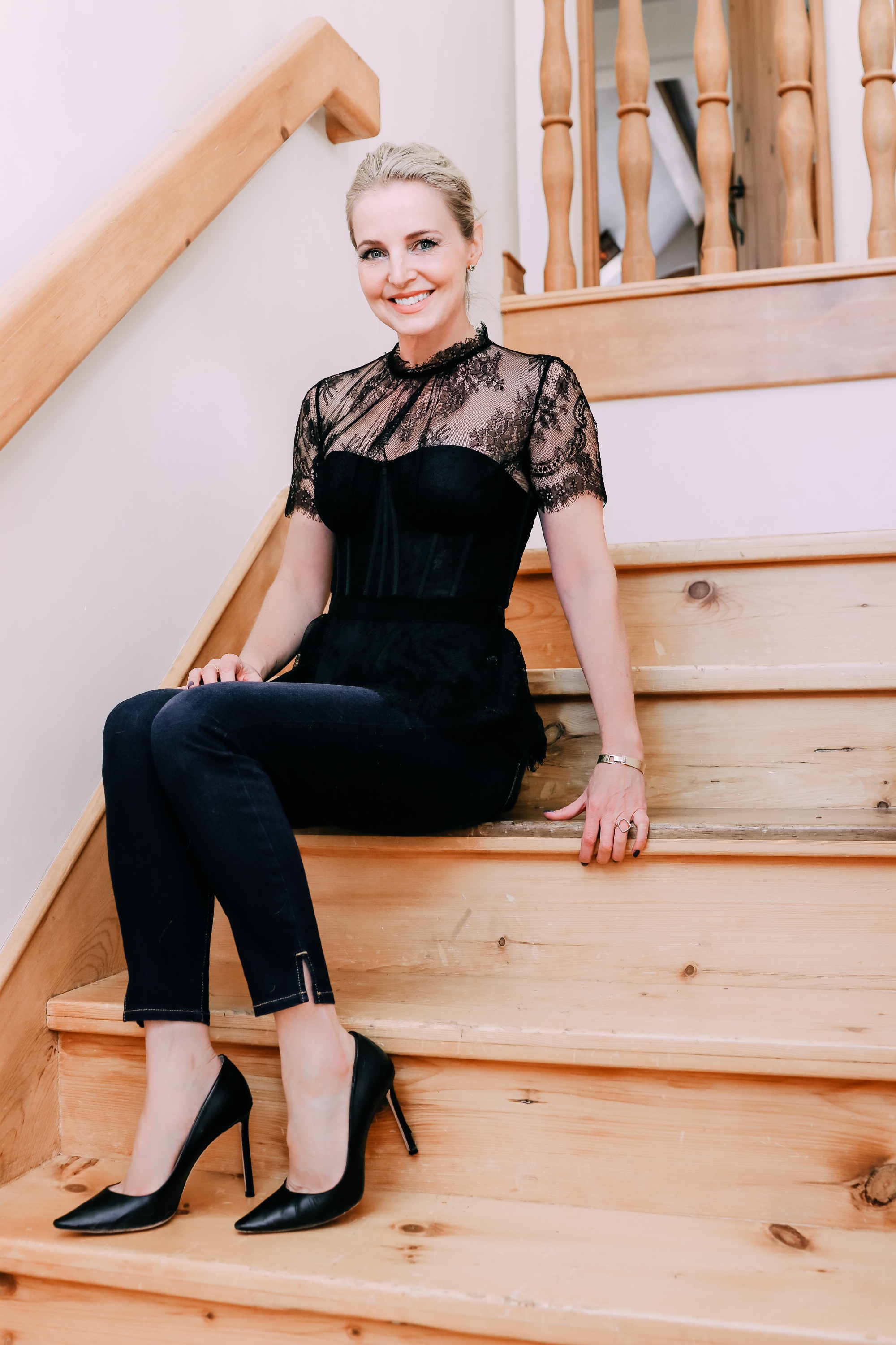 Holiday Outfits With Jeans, Erin Busbee of Busbee Style wearing a black lace corset top by Jonathan Simkhai, L'Agence dark wash skinny jeans, and black Jimmy Choo Romy pumps from Nordstrom in Telluride, Colorado