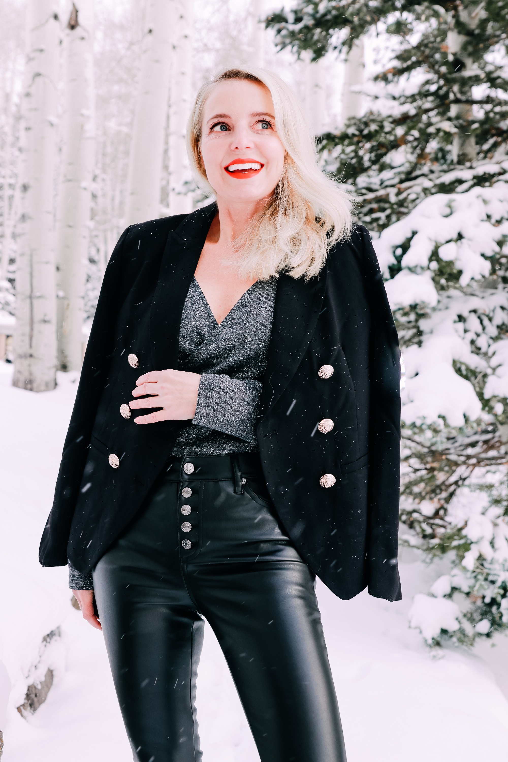 Holiday Party Outfits, Erin Busbee of Busbee Style wearing a black double breasted crepe blazer by Scoop over a metallic wrap style bodysuit but Sofia Vergara with black faux leather high rise skinny jeans by Scoop and black stiletto booties by Scoop in the snow in Telluride, Colorado