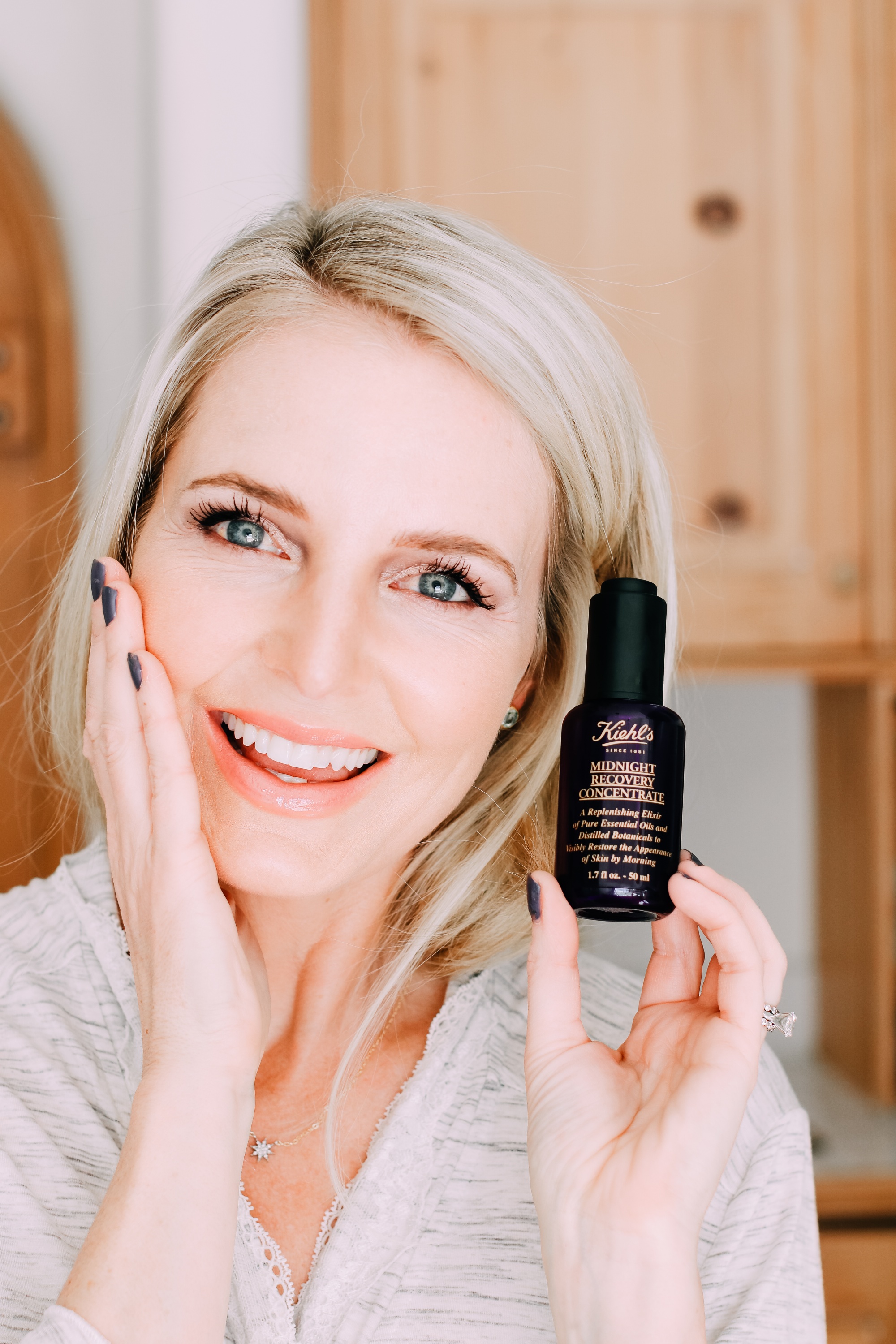 Skincare Gifts, Erin busbee of Busbee Style holding the Midnight Recovery Concentrate Face Oil by Kiehl's from Nordstrom wearing a gray robe in Telluride, Colorado