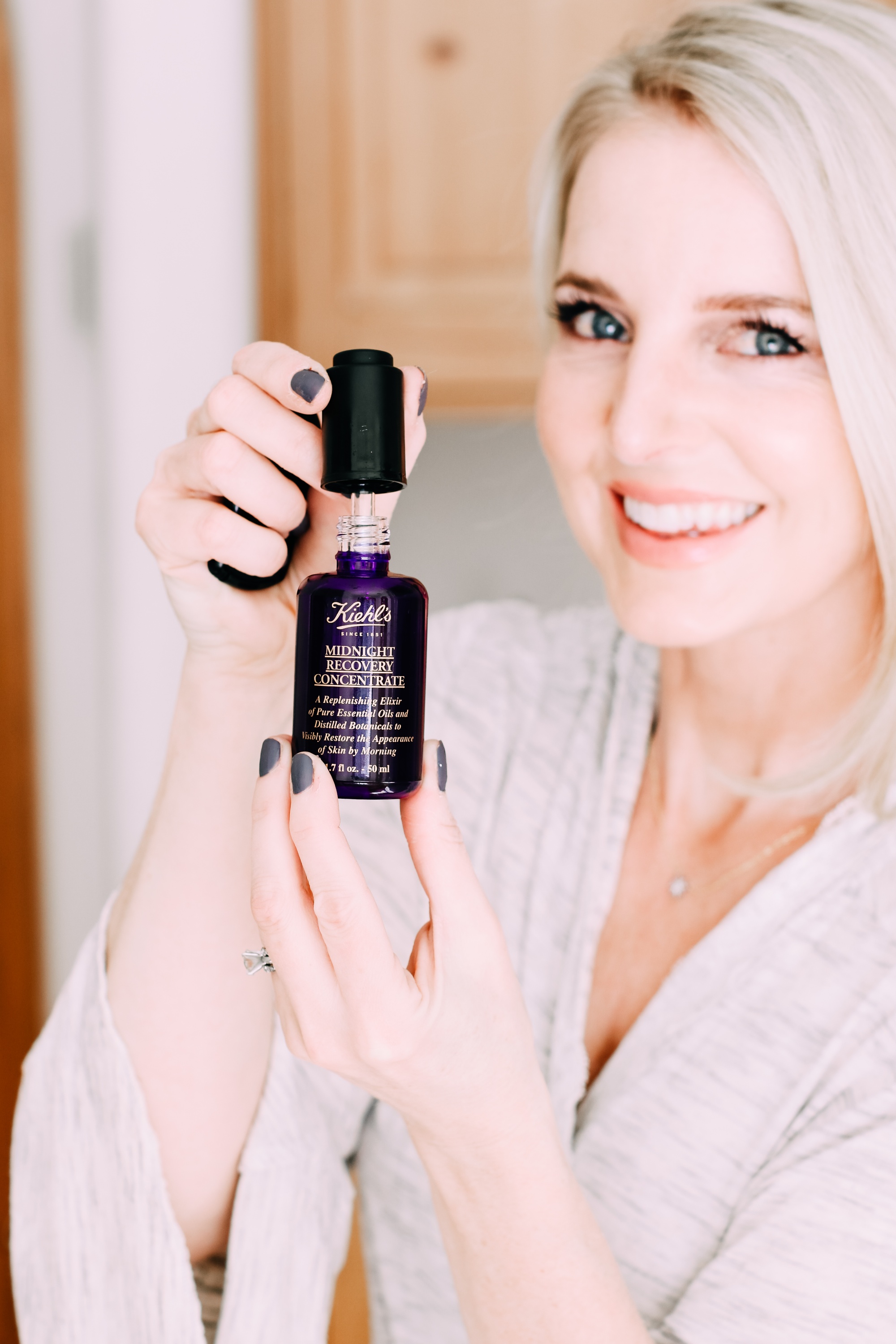 Skincare Gifts, Erin busbee of Busbee Style holding the Midnight Recovery Concentrate Face Oil by Kiehl's from Nordstrom wearing a gray robe in Telluride, Colorado