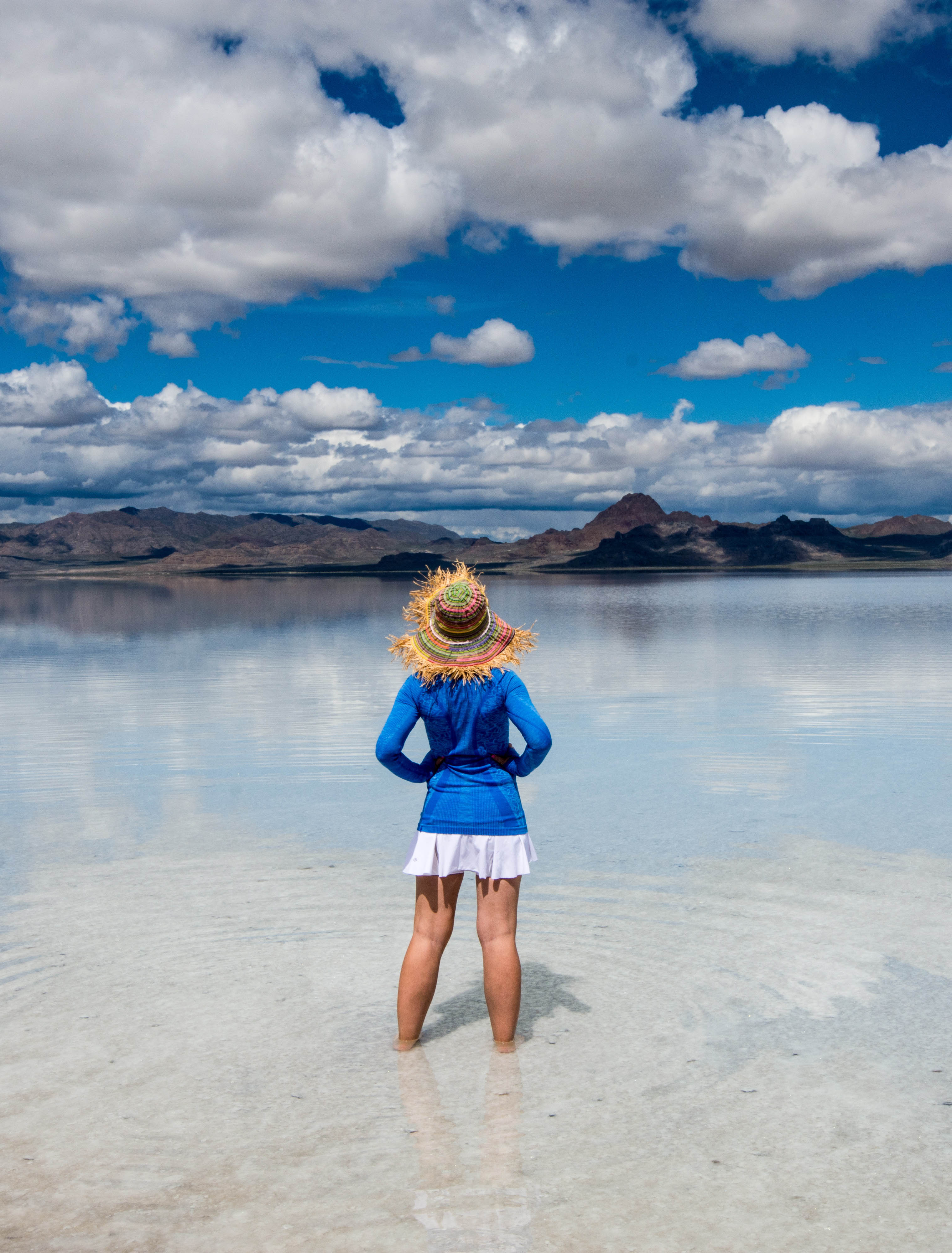 Best remote destinations, woman standing alone in the middle of the Bonneville Salt Flats in Utah