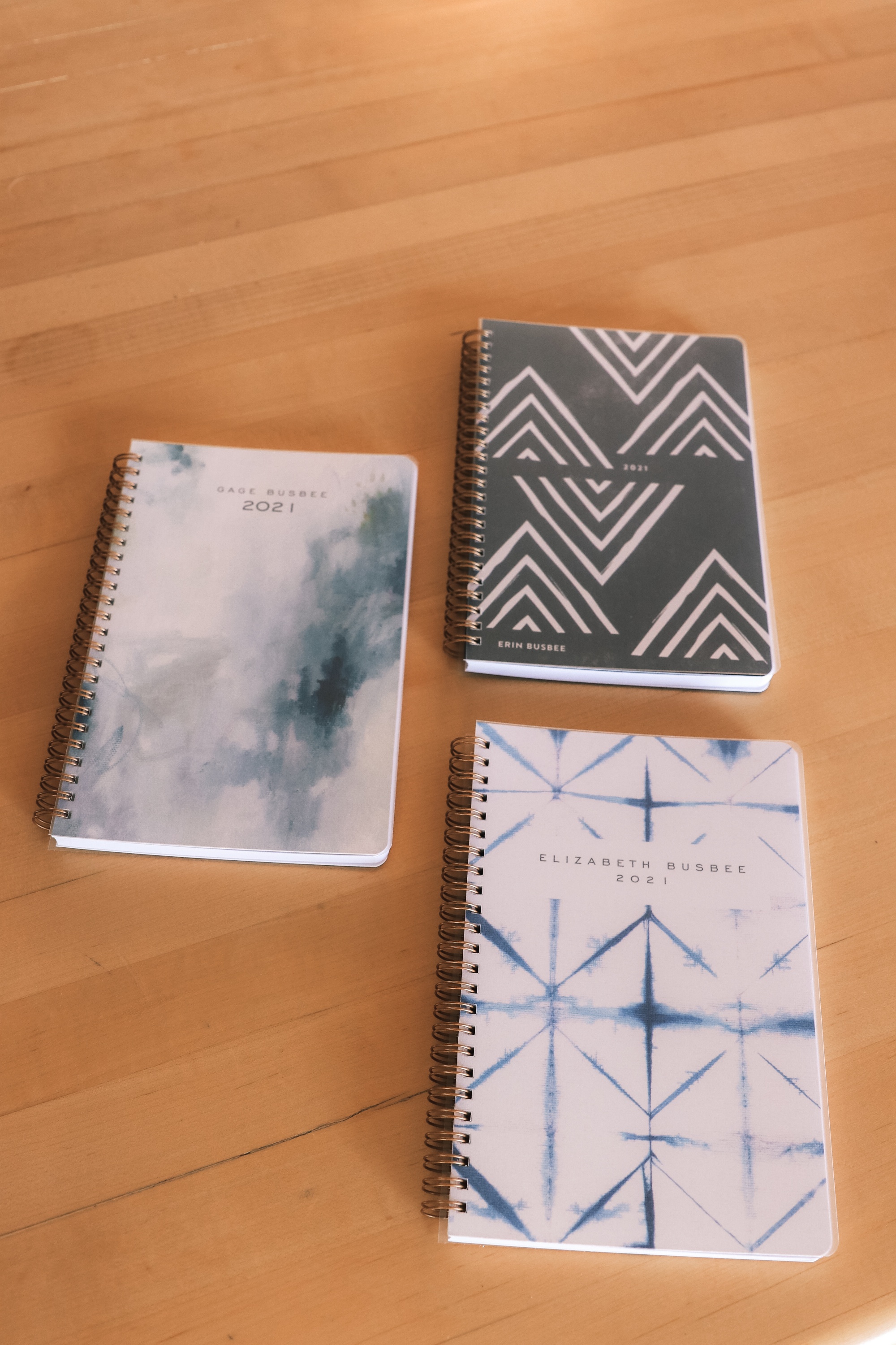 Personalized Gifts, Erin Busbee of Busbee Style sharing three customized planners for her son, daughter, and herself in a blue in Telluride, Colorado
