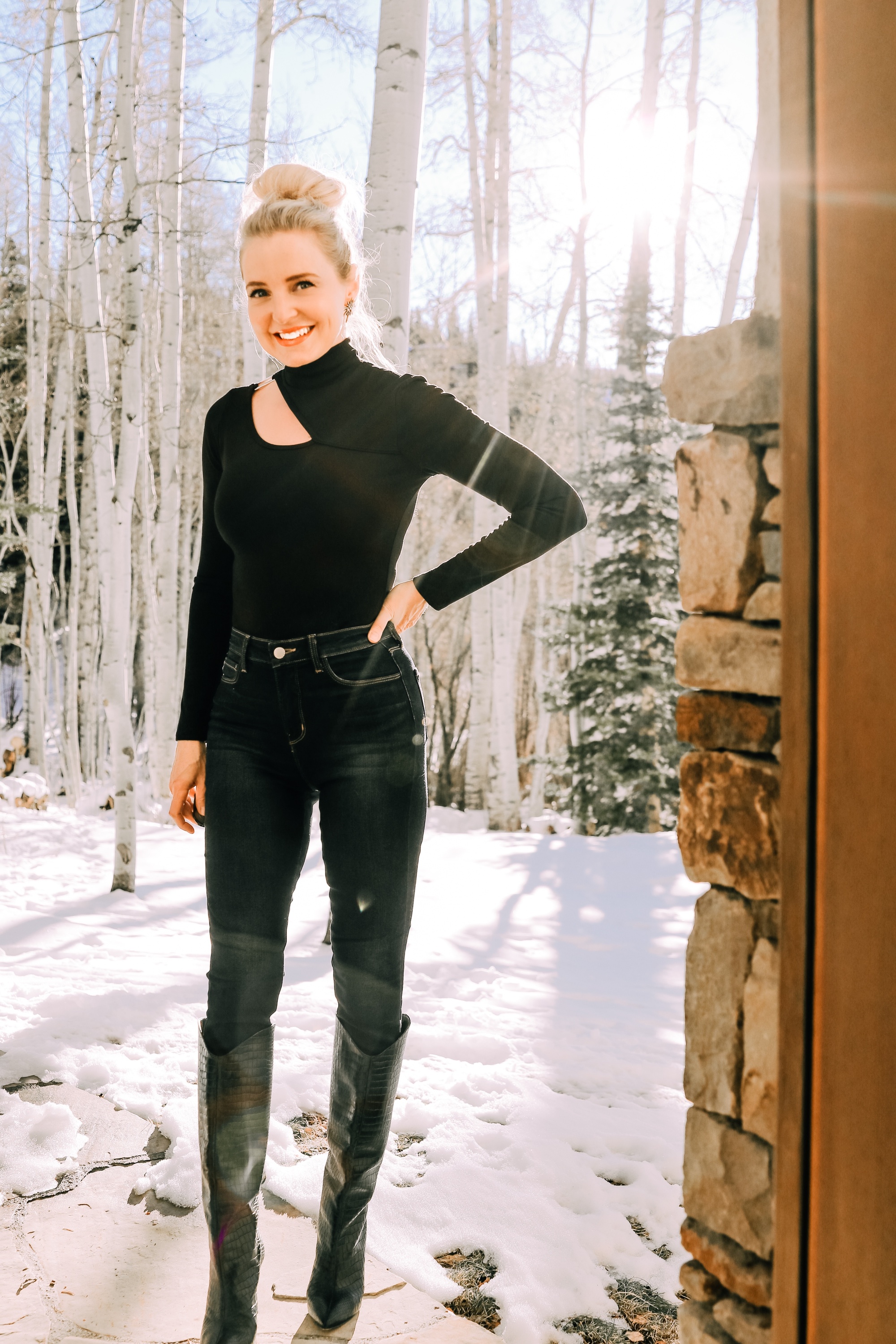 Holiday outfit ideas featuring black turtleneck with cutout and dark wash skinny jeans