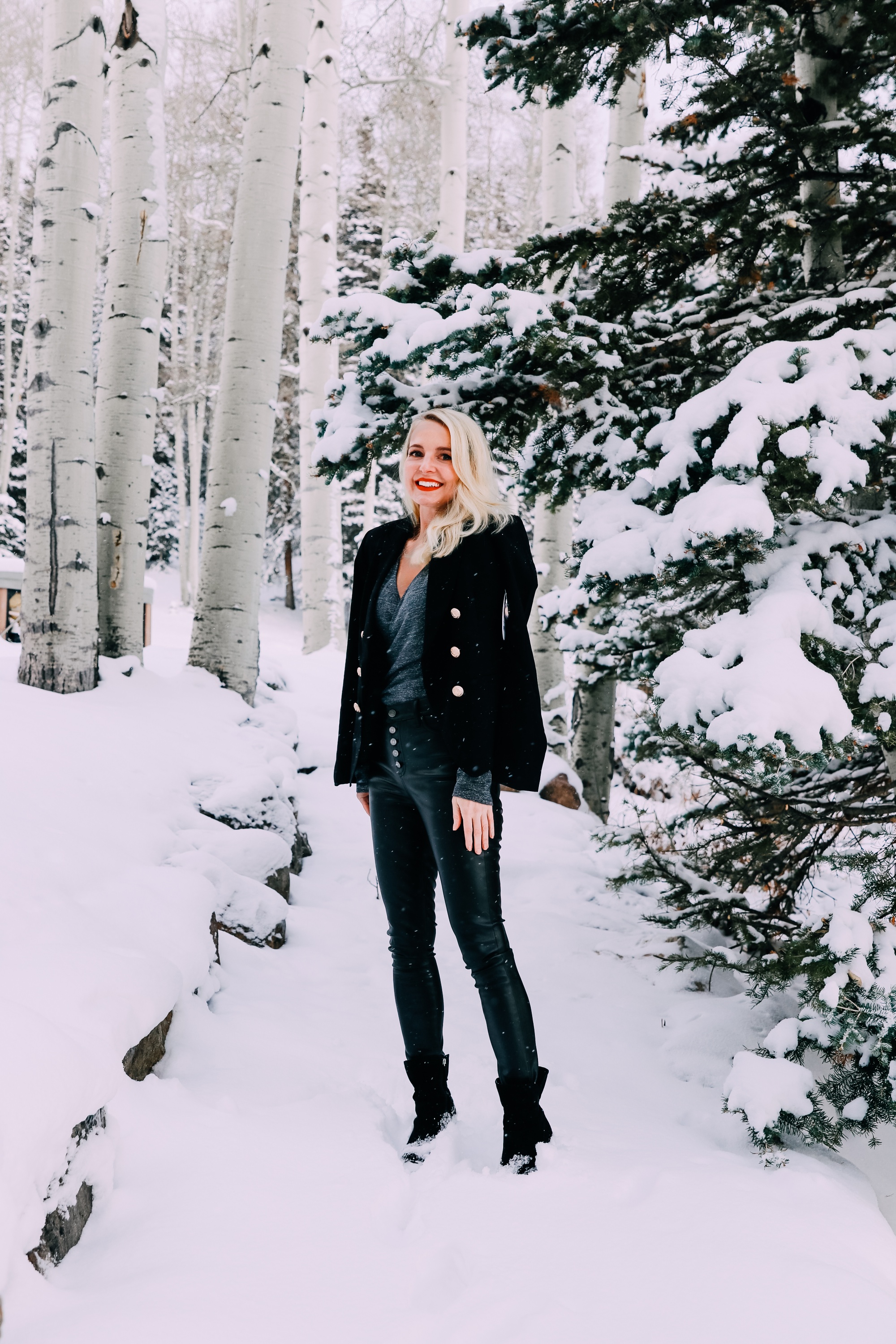Holiday Party Outfits, Erin Busbee of Busbee Style wearing a black double breasted crepe blazer by Scoop over a metallic wrap style bodysuit but Sofia Vergara with black faux leather high rise skinny jeans by Scoop and black stiletto booties by Scoop in the snow in Telluride, Colorado