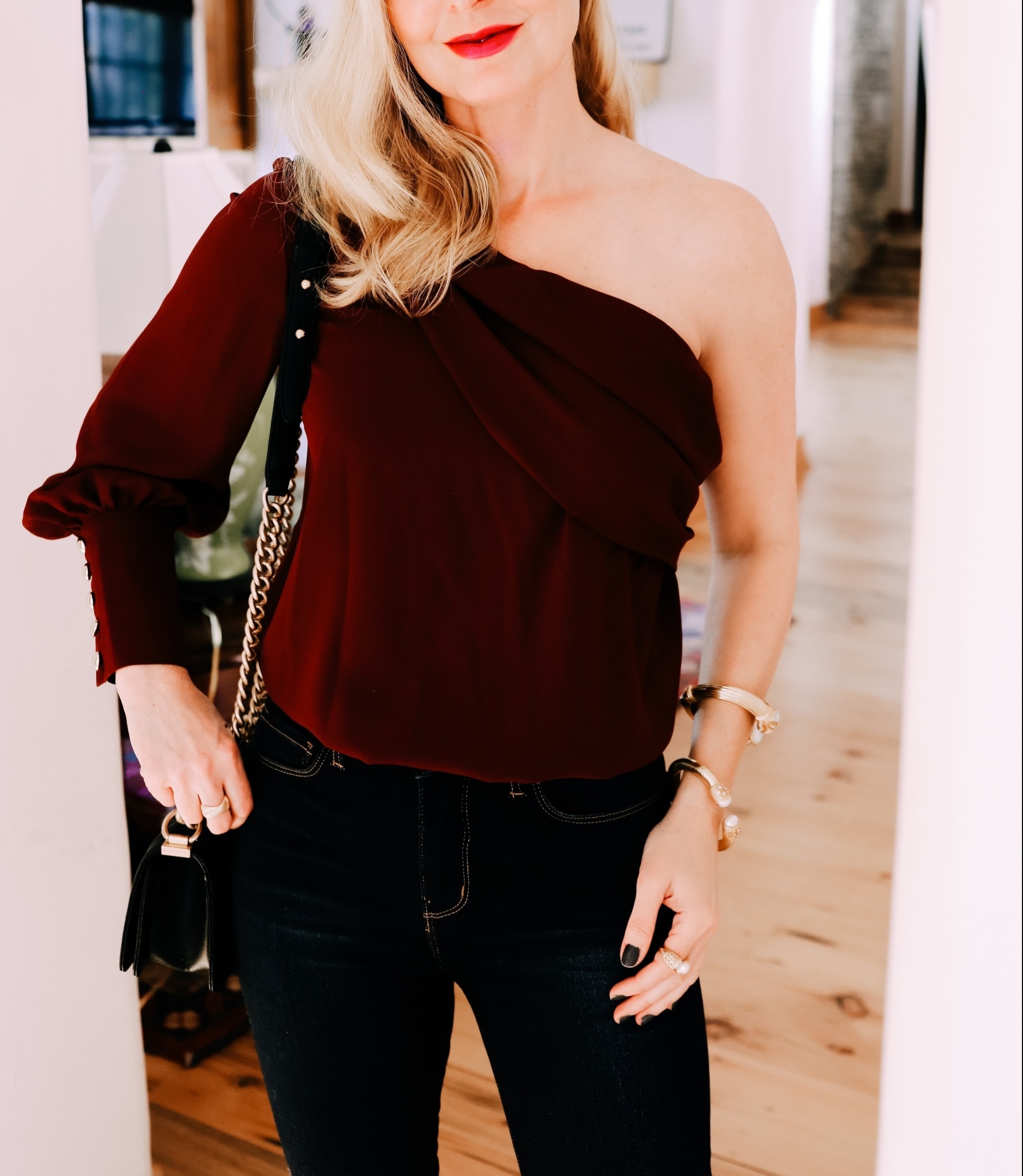 burgundy one-shoulder blouse | How To Dress Up Jeans For A Holiday Party