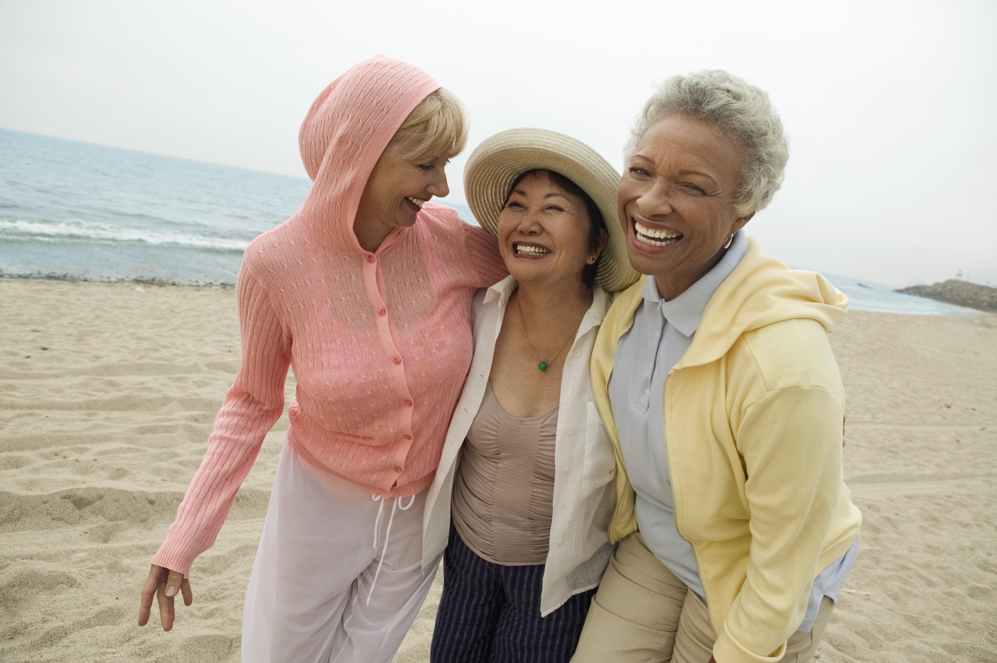 positive things about menopause, Portrait of happy middle aged female friends enjoying vacation at beach
