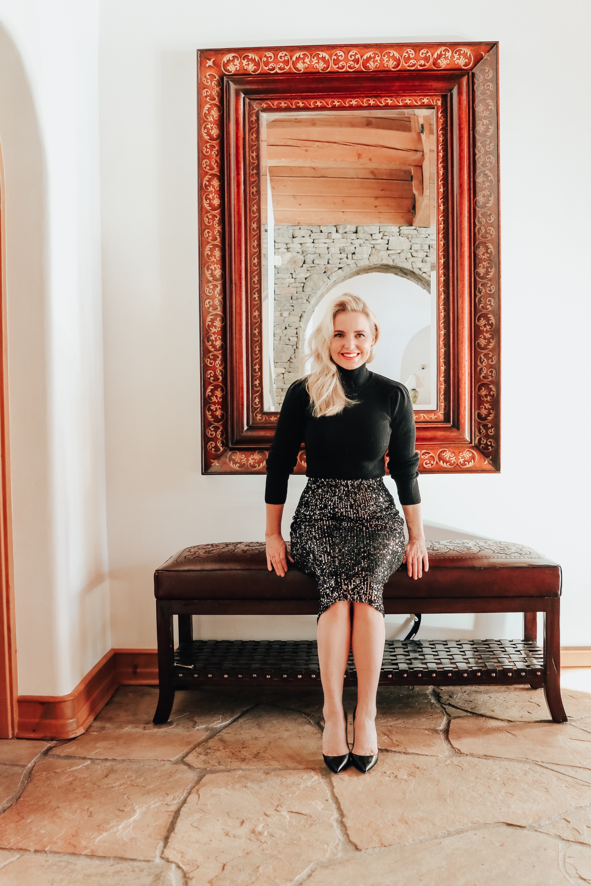 Simple holiday outfit idea featuring sequin midi skirt and black puff shoulder ribbed turtleneck from Walmart on fashion over 40 blogger Erin Busbee