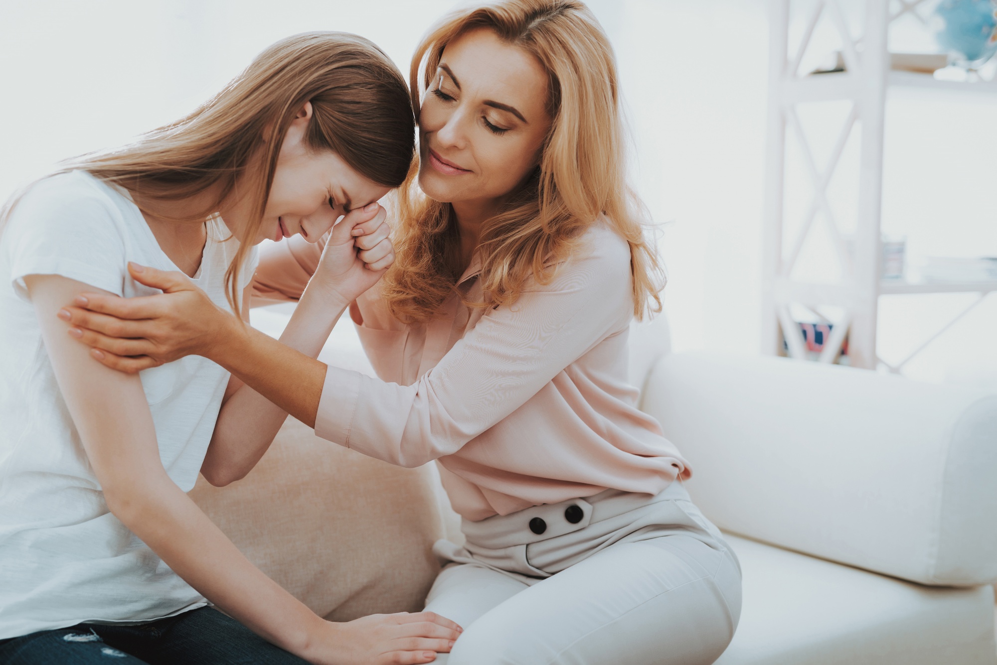 talking about sex, mother at home comforting her teenage daughter
