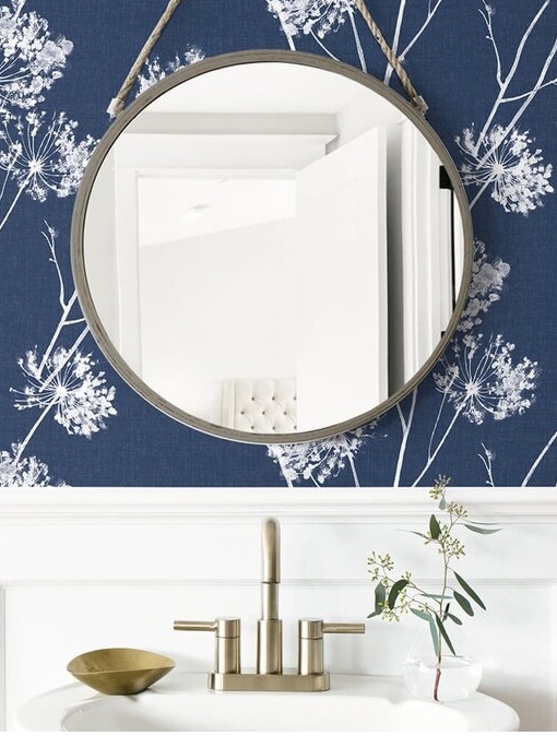 How To Update Your Powder Room With These 4 Easy Changes including peel and stick removeable wallpaper in a floral blue pattern on the vanity wall.