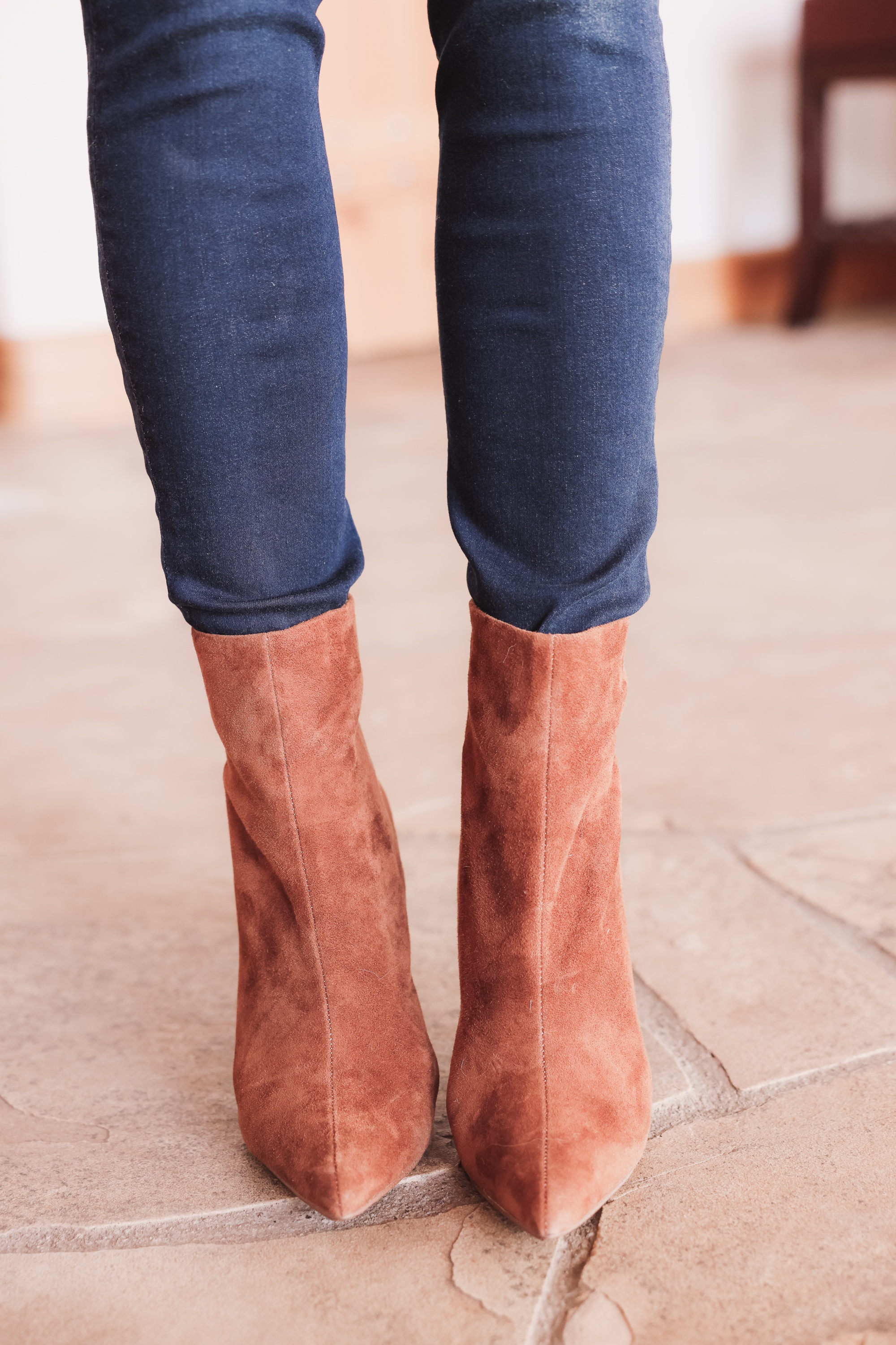 Best brown booties, Erin Busbee of Busbee wearing an ASTR the Label sculptural sleeve sweater with rag & bone skinny jeans and brown suede stiletto heel booties by Steve Madden from Nordstrom in Telluride, Colorado