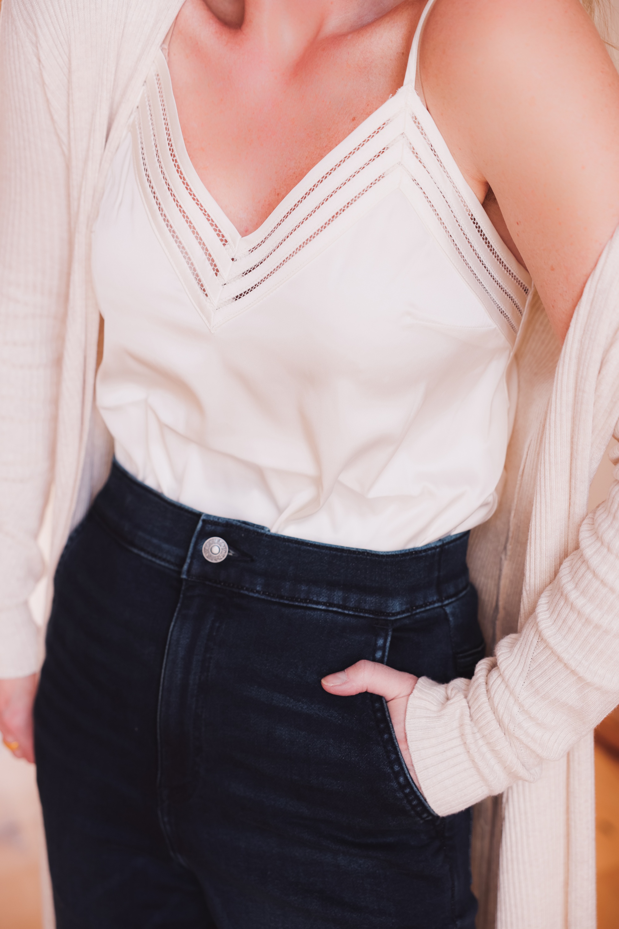 Express Sale, Erin Busbee of Busbee wearing denim joggers, a white satin cami, and long ribbed duster cardigan from Express with Steve Madden brown booties in Telluride, Colorado