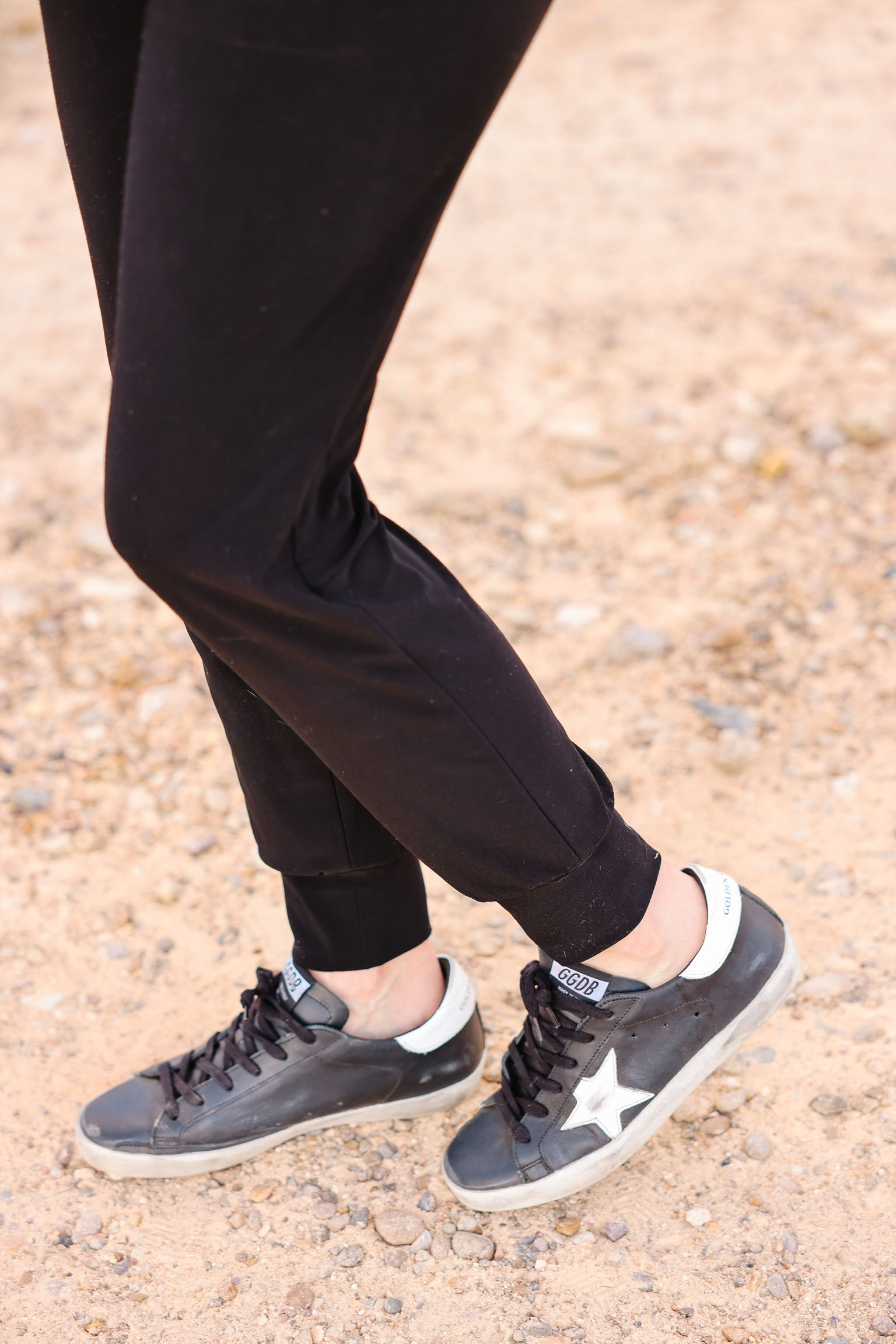 Elevated Basics, Erin Busbee of Busbee wearing black golden goose sneakers with black joggers by Norma Kamali in south texas
