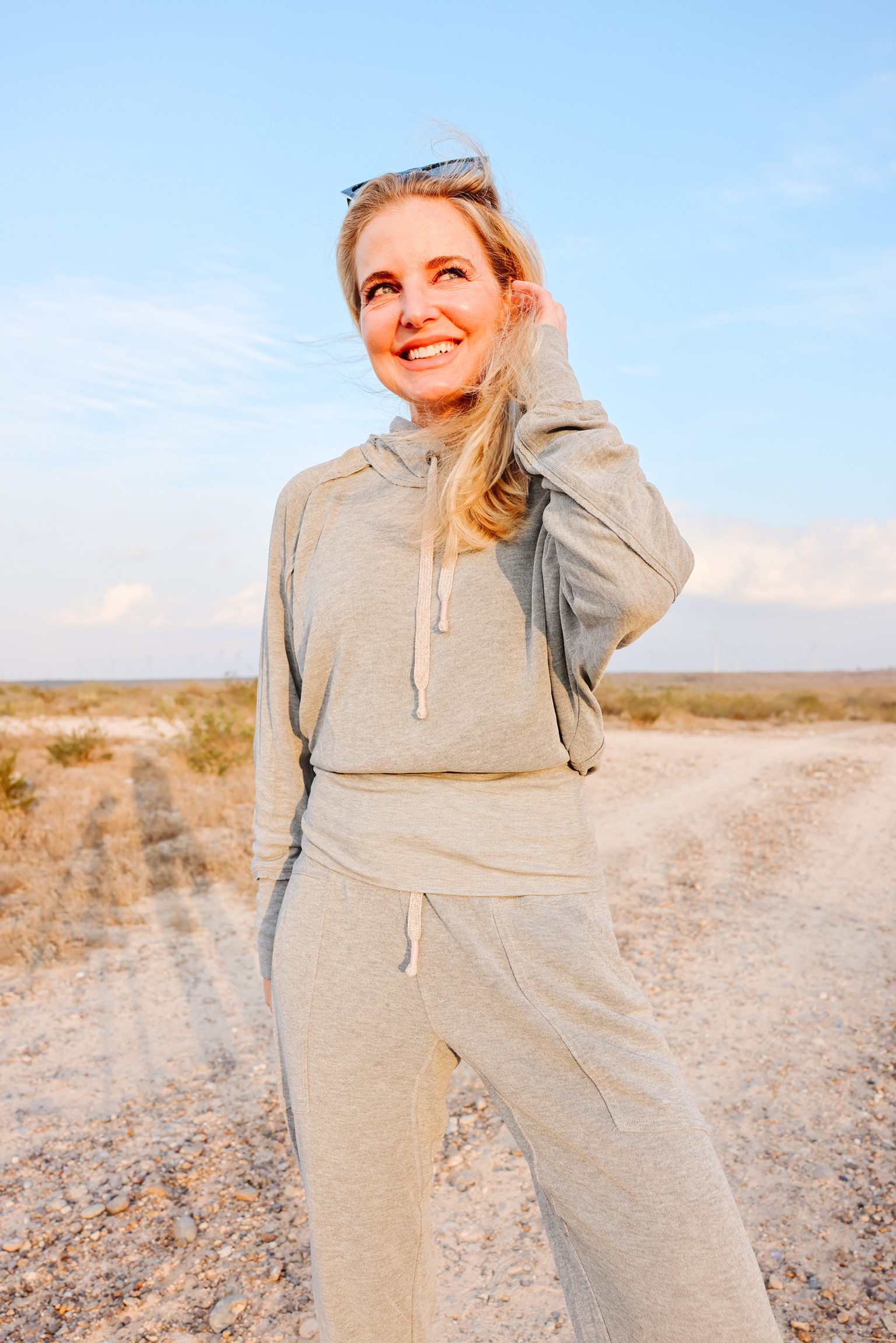 Cozy Loungewear, Erin Busbee of Busbee wearing the grey ready go hoodie by Free People with matching gray ready go pants from Free People with black golden goose sneakers in south texas