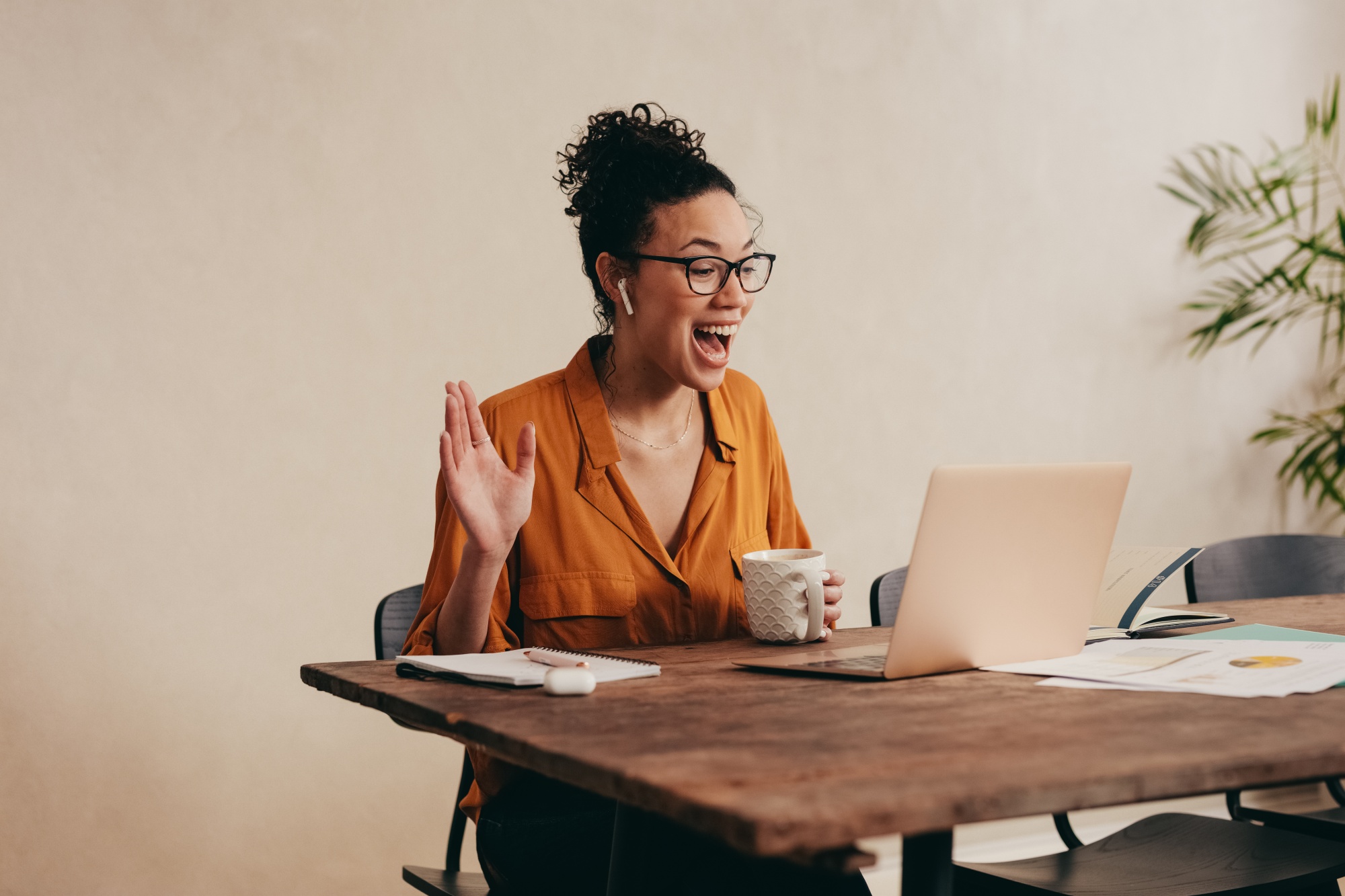 How-to-plan-a-Galentines-Day-zoom-party-celebration-your-friends-will-love-as-a-women-sits-at-a-table-for-the-zoom-party