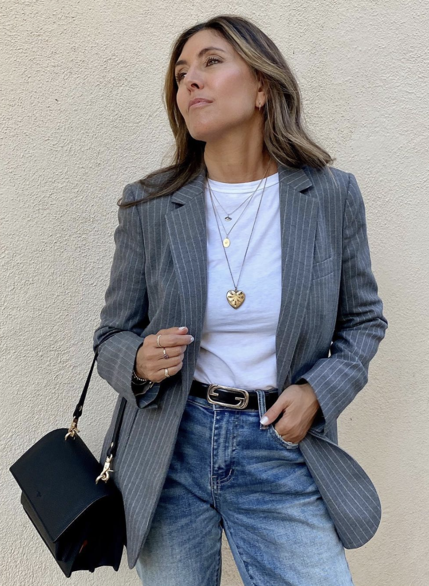 Styling Blazers Over 40, Melissa Meyers from The Glow Girl wearing a gray pinstripe blazer with white tee, jeans, black bag, and simple gold jewelry, Melissa Meyers fashion blogger, over 40 style