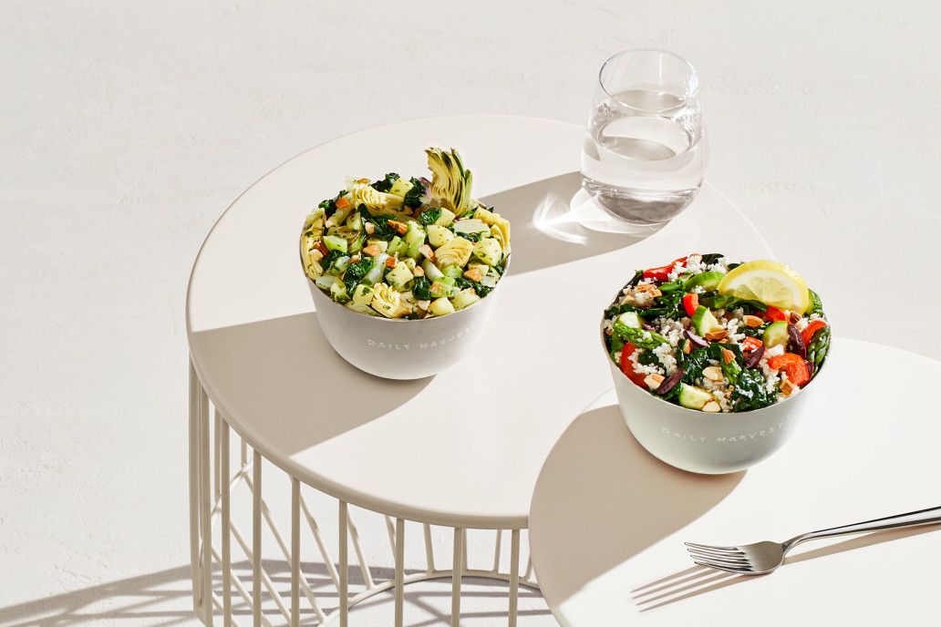 best meal delivery services, Daily Harvest bowls of food and glass of water on a white table with white background