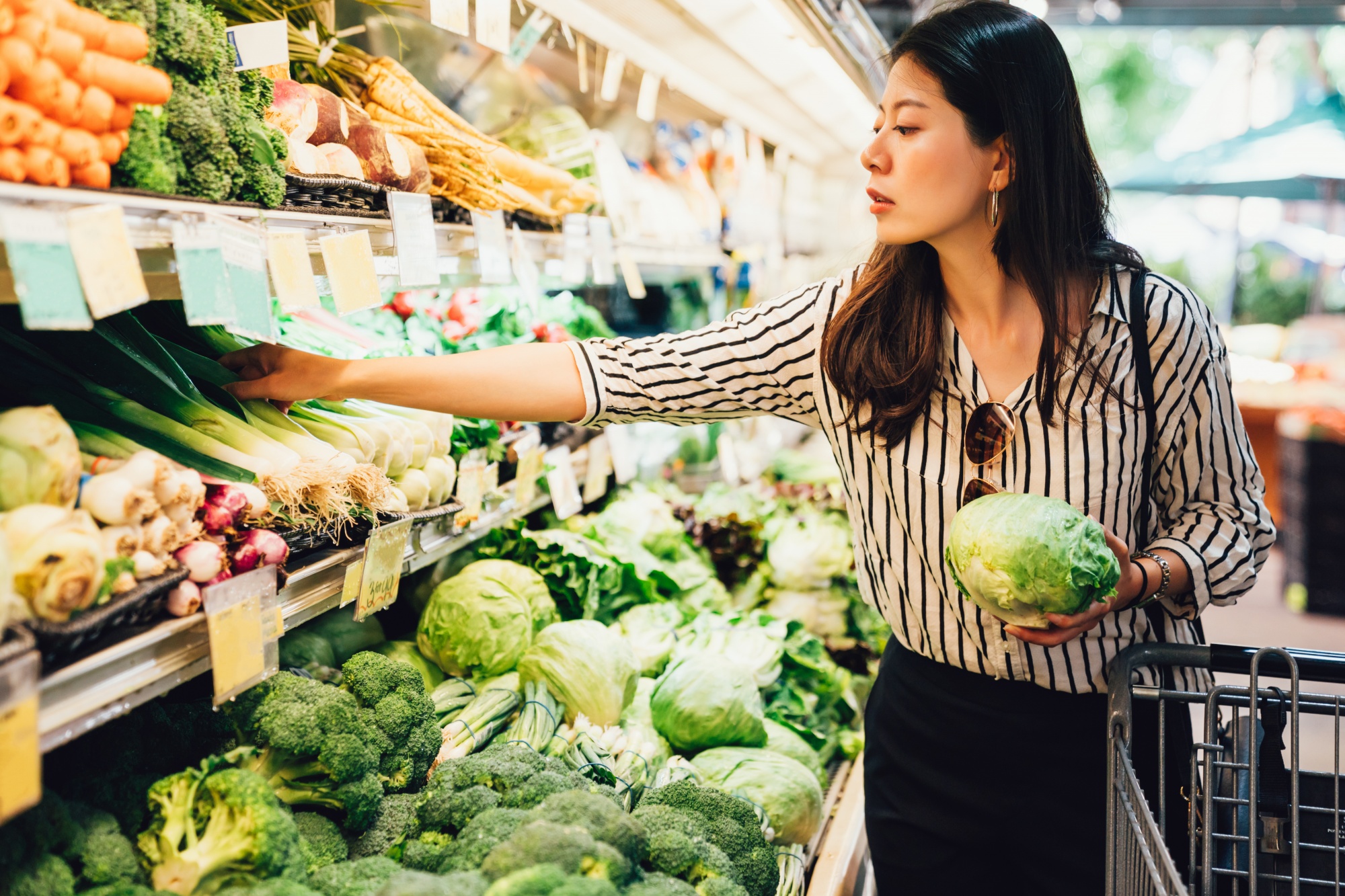 get rid of mummy tummy for good, Asian woman choosing vegetables at store
