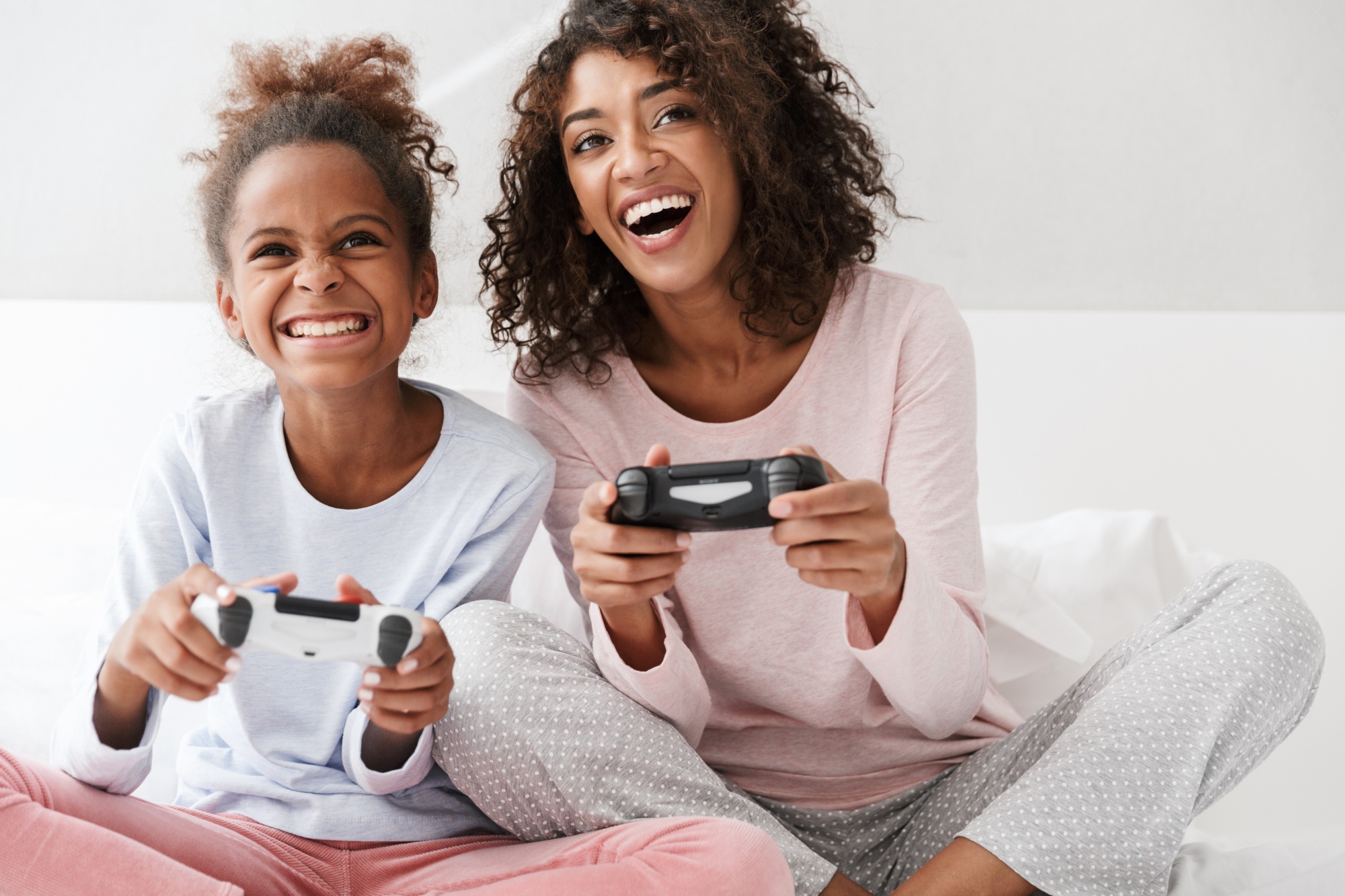 What is neuroplasticity? Black mom and daughter in pjs playing video games