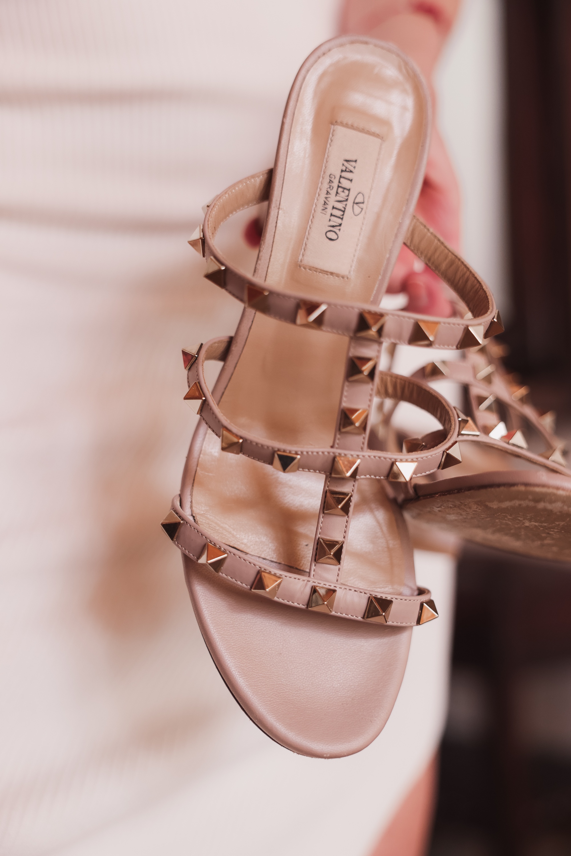 Valentino Rockstud sandals in beige paired with white knit tank dress