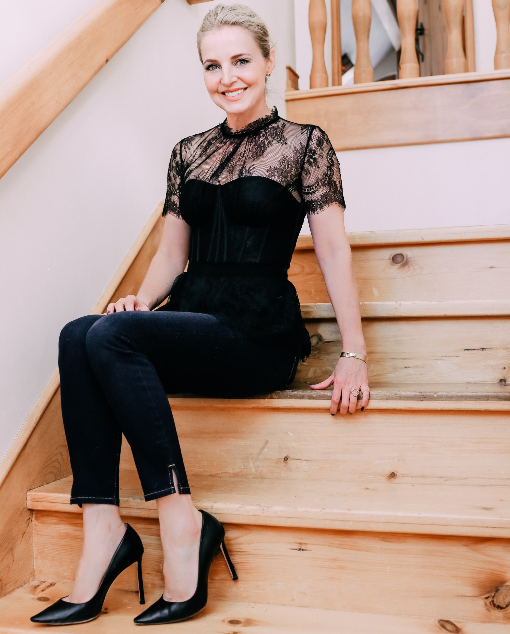 what shoes to wear with jeans featuring Jimmy Choo Romy pumps in black leather paired with dark wash skinny jeans and a black lace corset top by Jonathan Simkhai on fashion over 40 blogger Erin Busbee