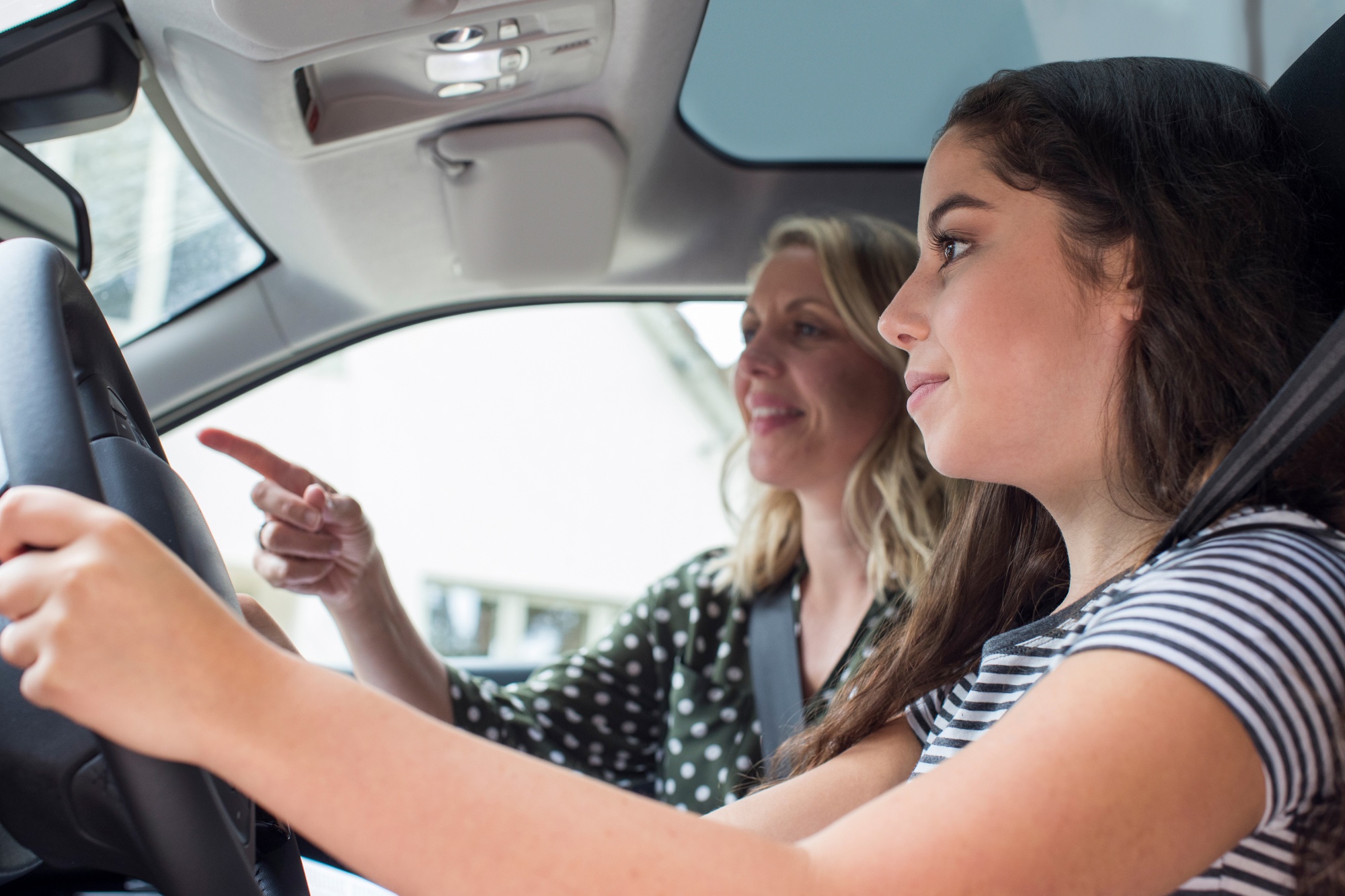 budget for when you have teens, mother teaching daughter how to drive