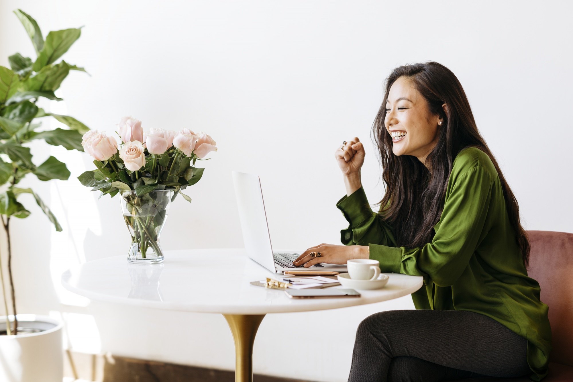 dating profile after 40, Asian woman smiling happy while writing on laptop