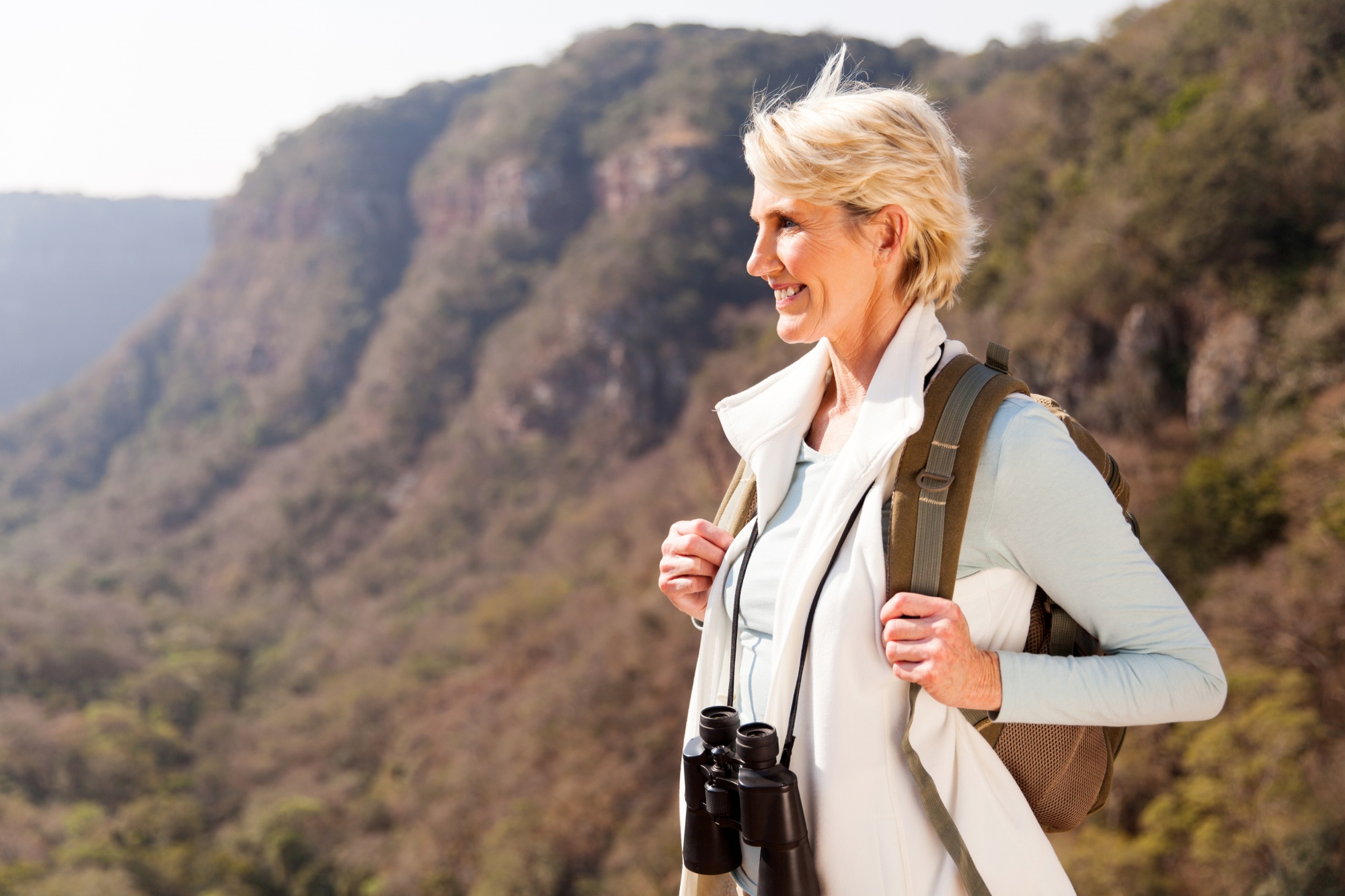 why reinventing yourself makes you younger, beautiful hiker enjoying the view from top of a mountain