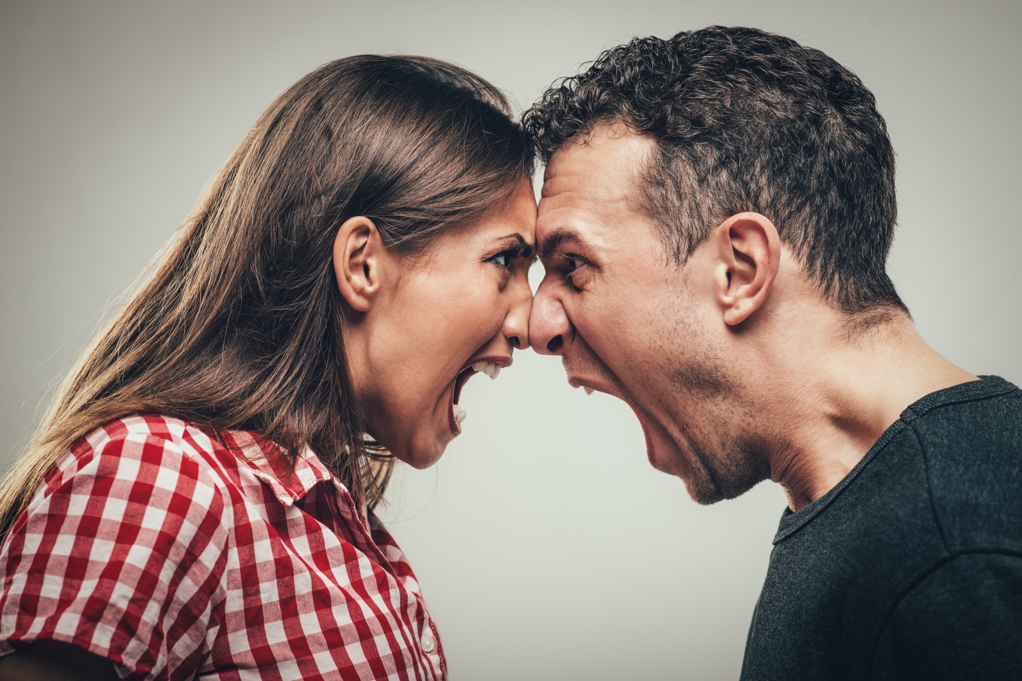 fighting fairly in your relationship, man and woman married couple face to face screaming