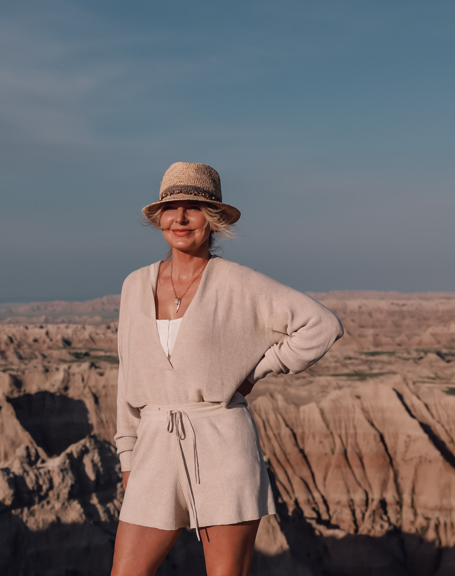 beige knit sweater and shorts set paired with packable straw fedora hat in Badlands National Park on fashion over 40 blogger Erin Busbee