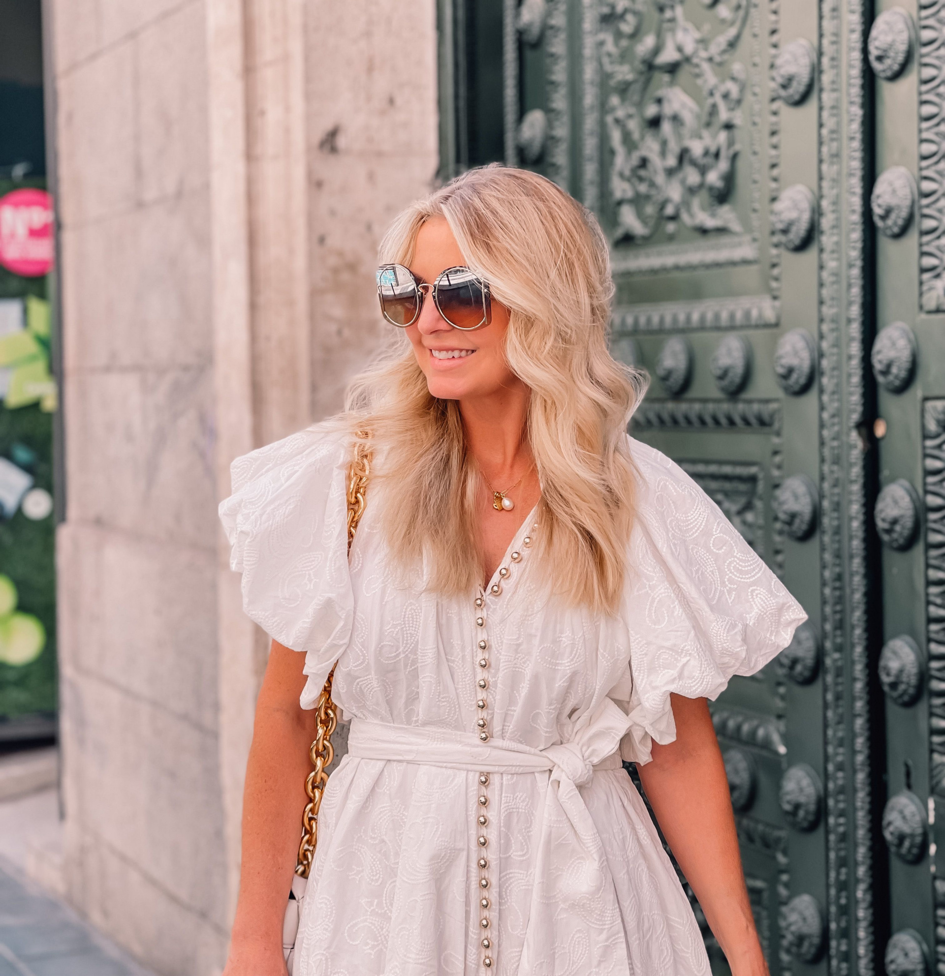 white dress by Acler with puff sleeves on fashion over 40 blogger Erin Busbee in Madrid Spain