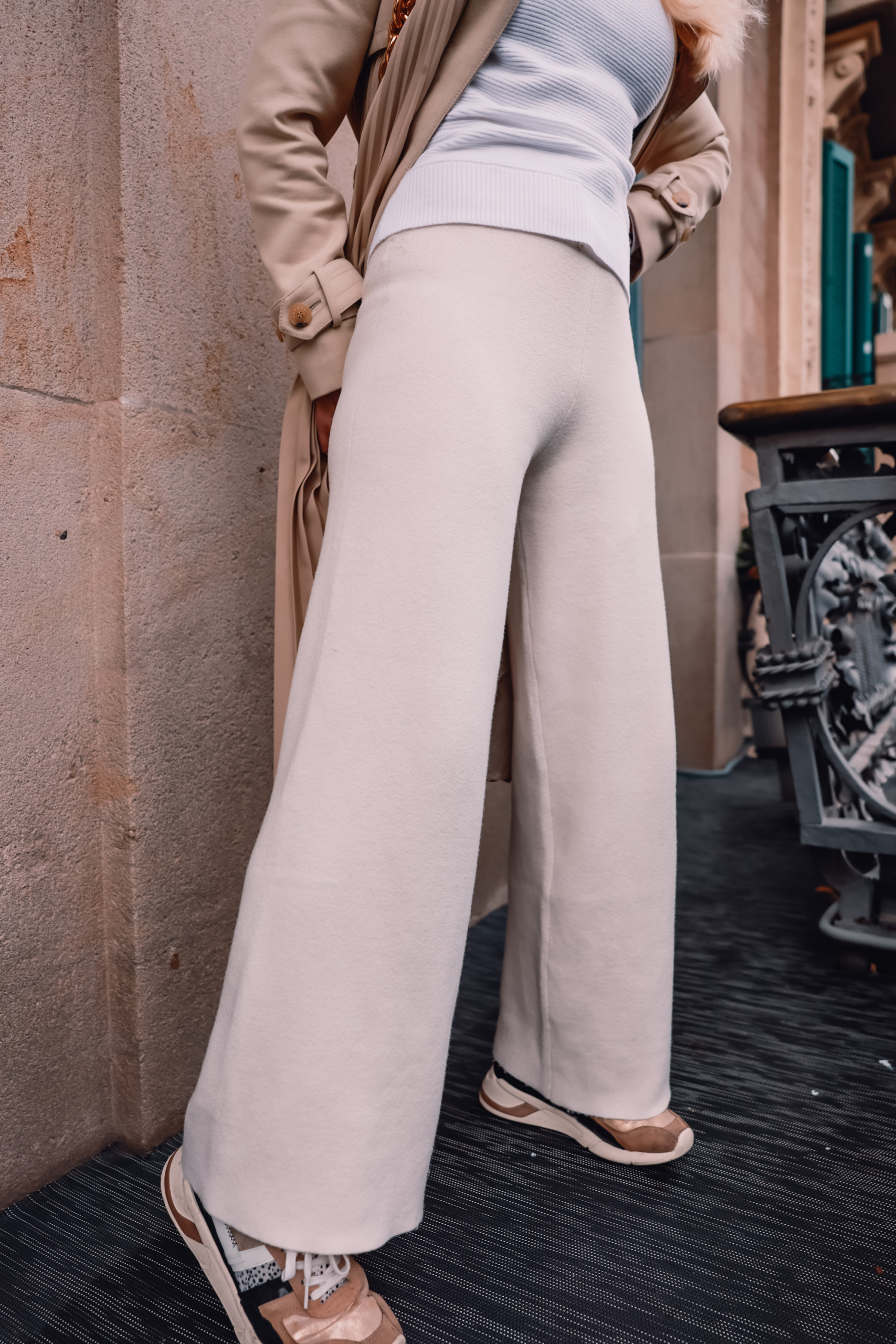 stylish loungewear, loungewear from couch to curb, how to transition loungewear, erin busbee, mango wide leg lounge pants, gola sneakers, white ribbed one shoulder sweater, mango quilted bucket hat, sandro trench, bottega veneta cassette bag, el palauet, barcelona, spain