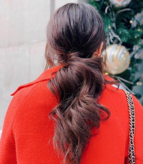 holiday hair tips, holiday hair brunette low ponytail red coat, best holiday hair, holiday hairstyle tips, holiday hair tips, hairstyle tips