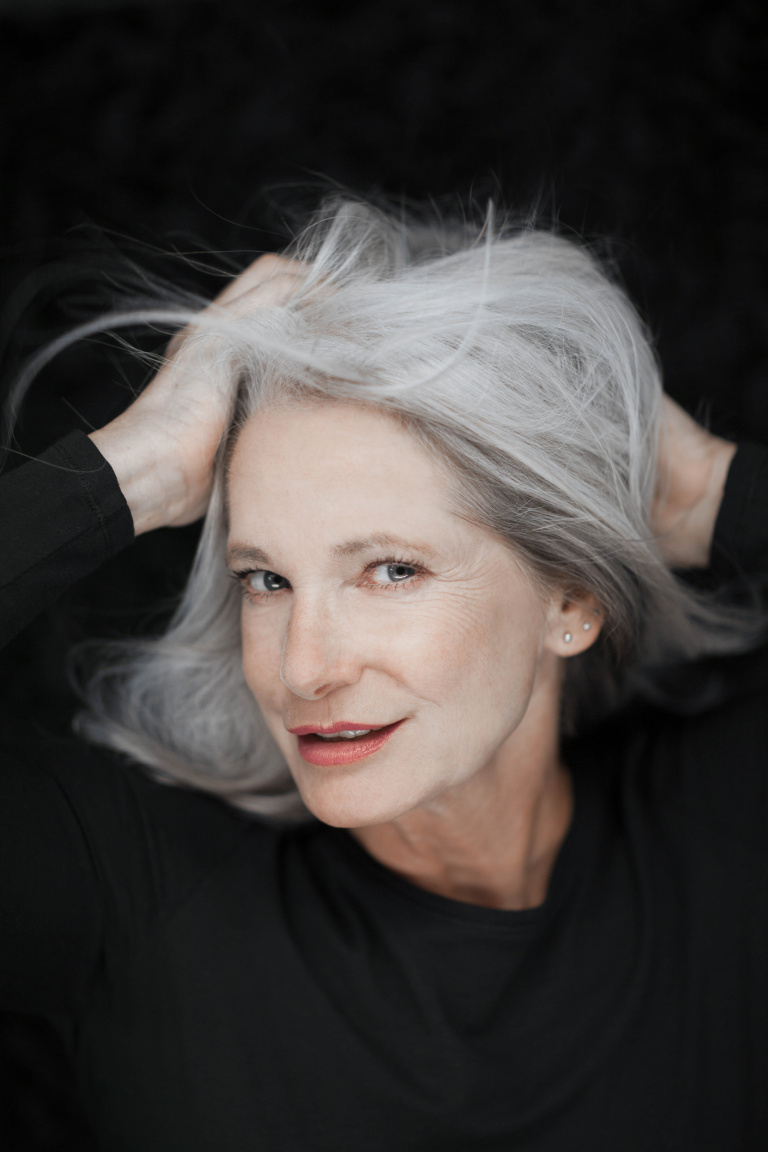woman posing with gray hair go gray, growing out gray hair, how to go gray, going gray gracefully
