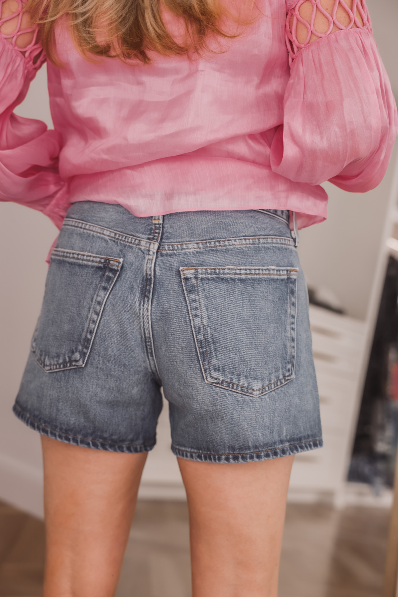 age appropriate denim shorts, denim shorts over 40, how to wear shorts over 40, erin busbee, busbee style, fashion over 40, agolde parker long vintage shorts in occurrence, , see by chloe wedges, pink aje blouse