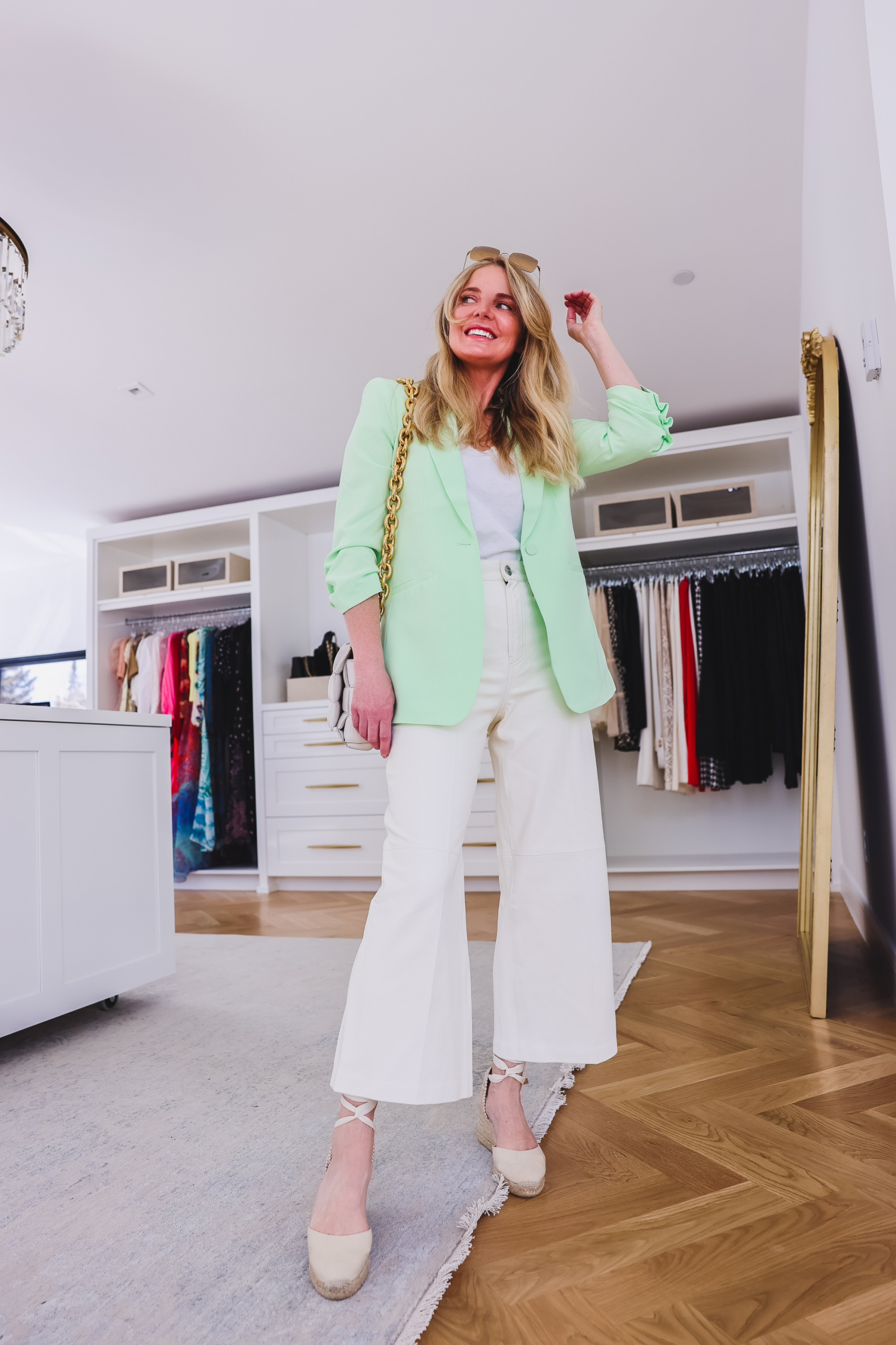 perfect spring outfit, spring outfit ideas, chic spring outfits, spring outfits over 40, european inspired outfits, how to dress like a european woman, european fashion trends 2022, erin busbee, busbee style, telluride, colorado, cinq á sept mint green ruched sleeve blazer, frame wide leg leather pants, soludos lace up espadrille wedges, atm white v-neck tee, bottega veneta white chain cassette bag, ray ban square sunglasses
