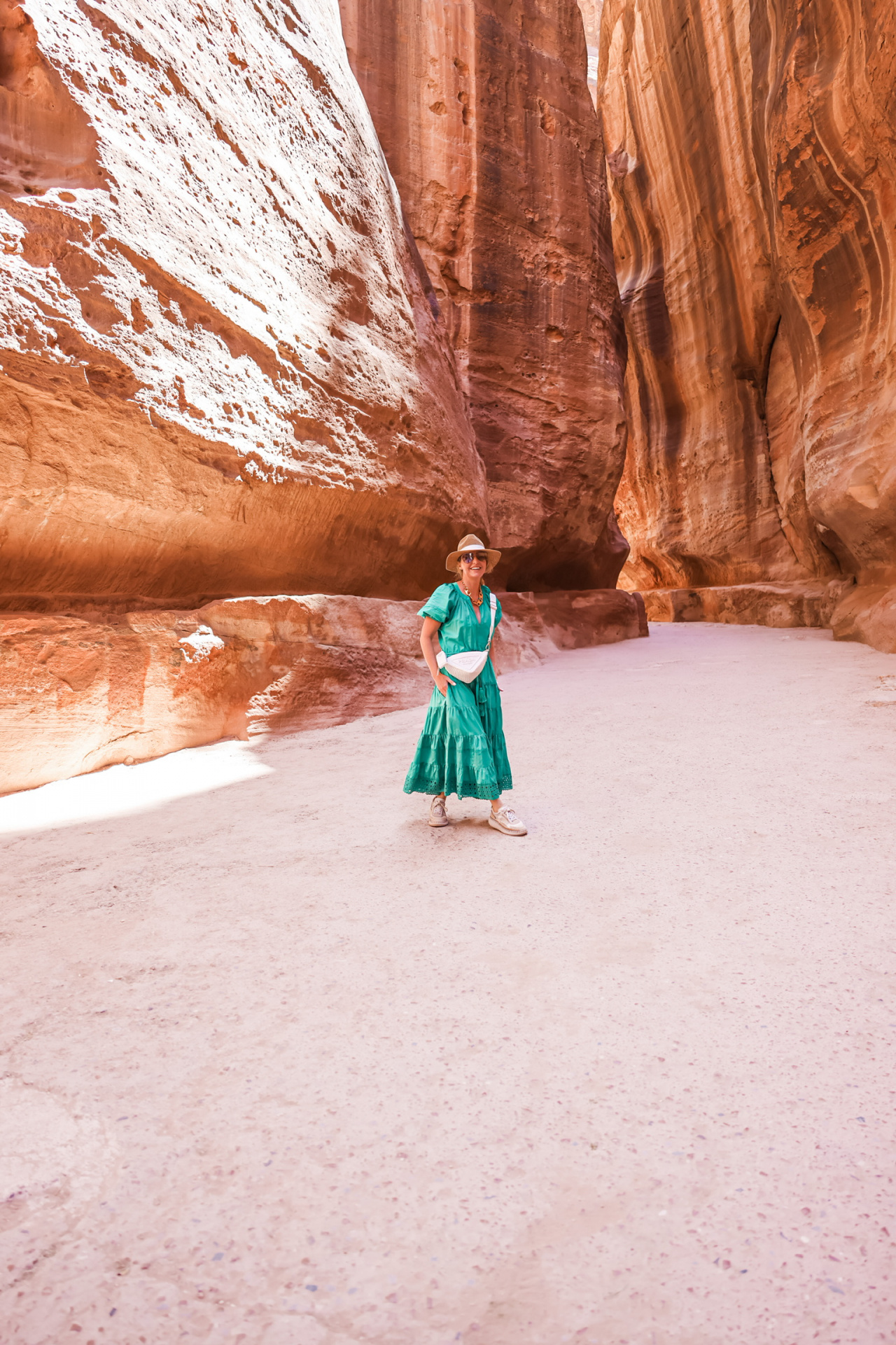 What I wore in Petra Jordan, featuring a green cotton Alexis midi dress, pink cashmere sweater, chloe sneakers